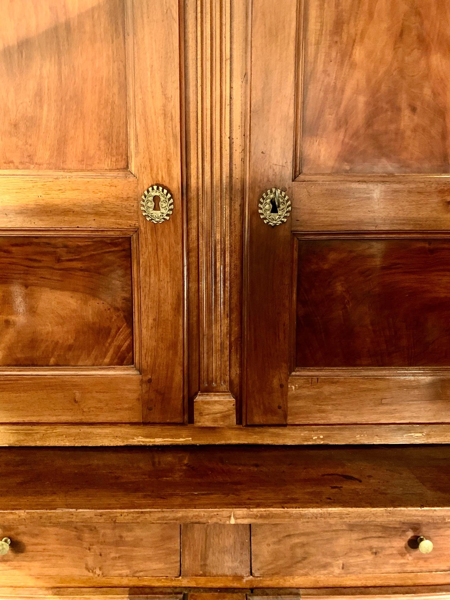 19th century French Directoire period oak bookcase or cabinet 
t has two parts that can be separated for easier transport. the upper part has a height of 125 cm with two doors and three adjustable shelves inside, the keyholes are in bronze.
the
