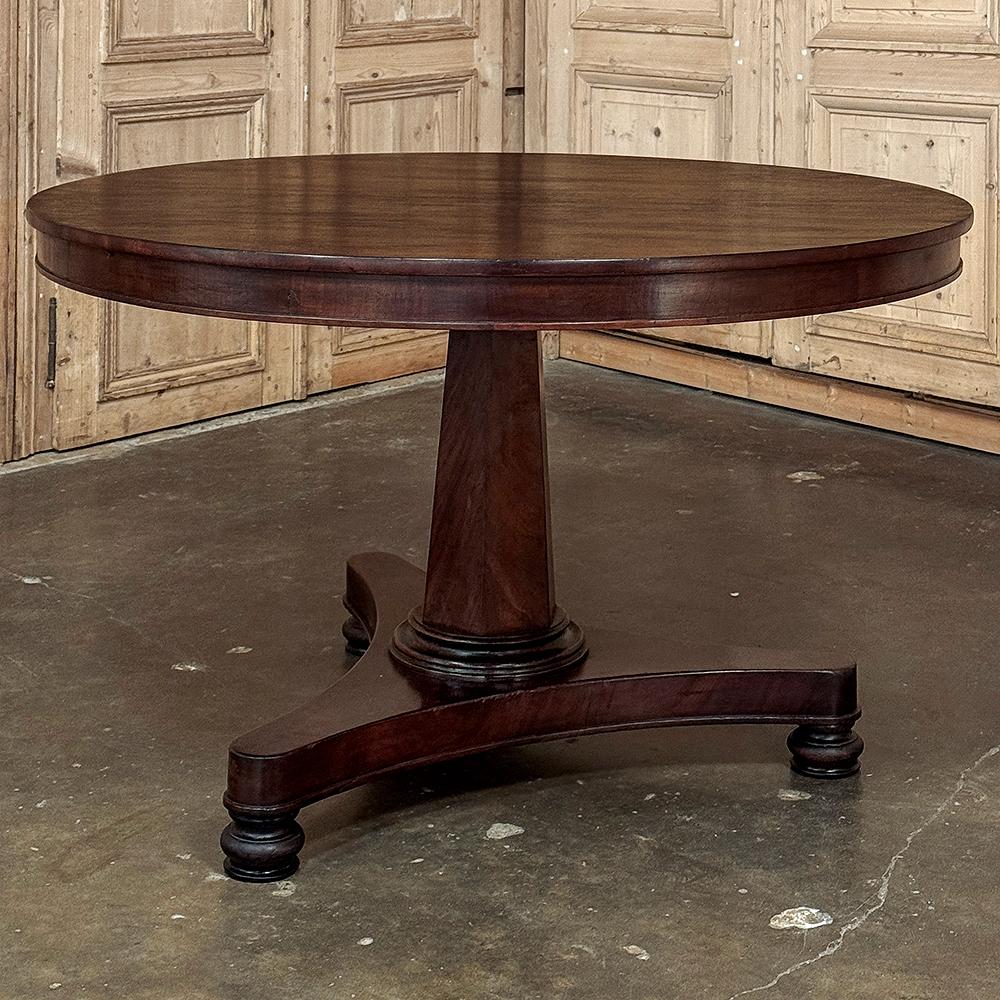 19th Century French Directoire Mahogany Round Dining Table reflects a sophisticated elegance that is truly timeless!  Hand-crafted from exotic imported mahogany from the Americas, it features a solid plank top with tailored apron all around,