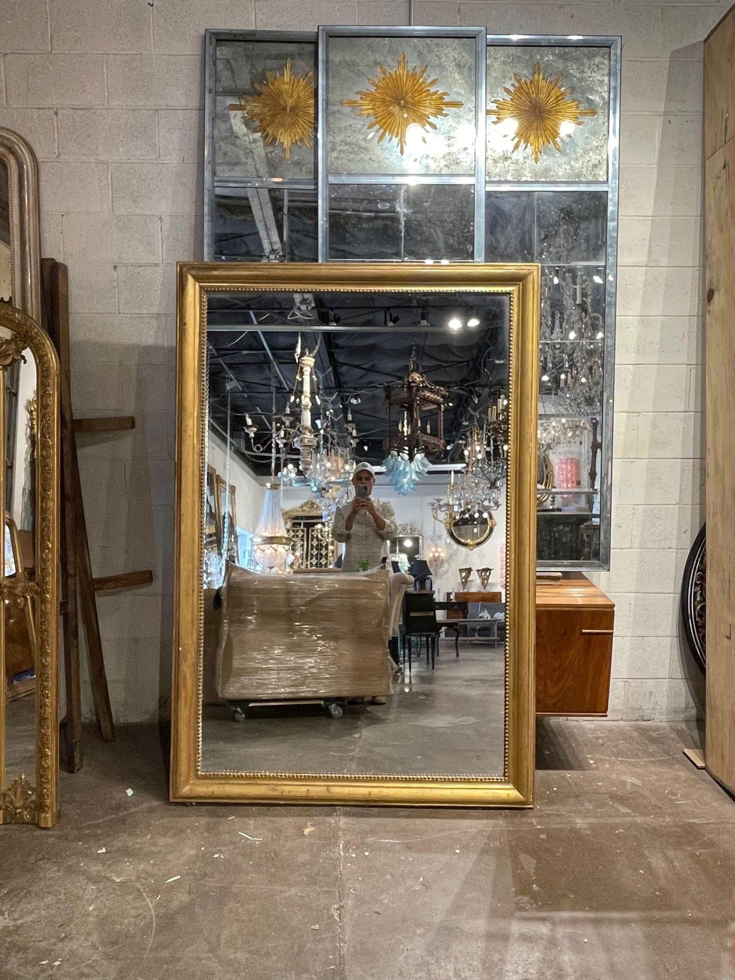Very fine 19th century Directoire style gold gilt mirror. This piece has a beautiful patina. A classic mirror that is great for a variety of decors! Lovely!.