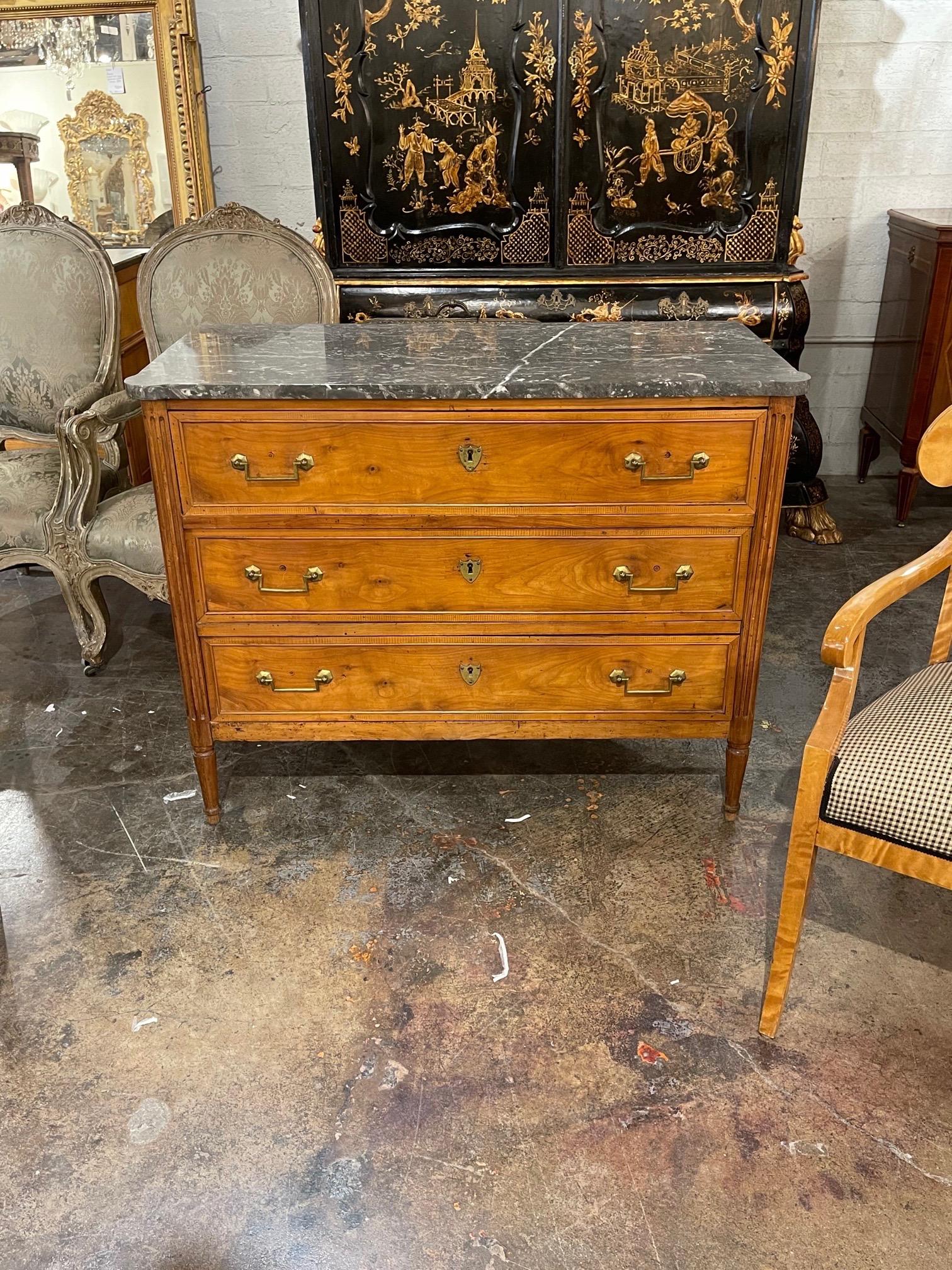 Handsome 19th century French Directoire walnut commode with a marble top. This piece has a beautiful finish and nice brass hardware as well. A classic chest for a variety of decors!
