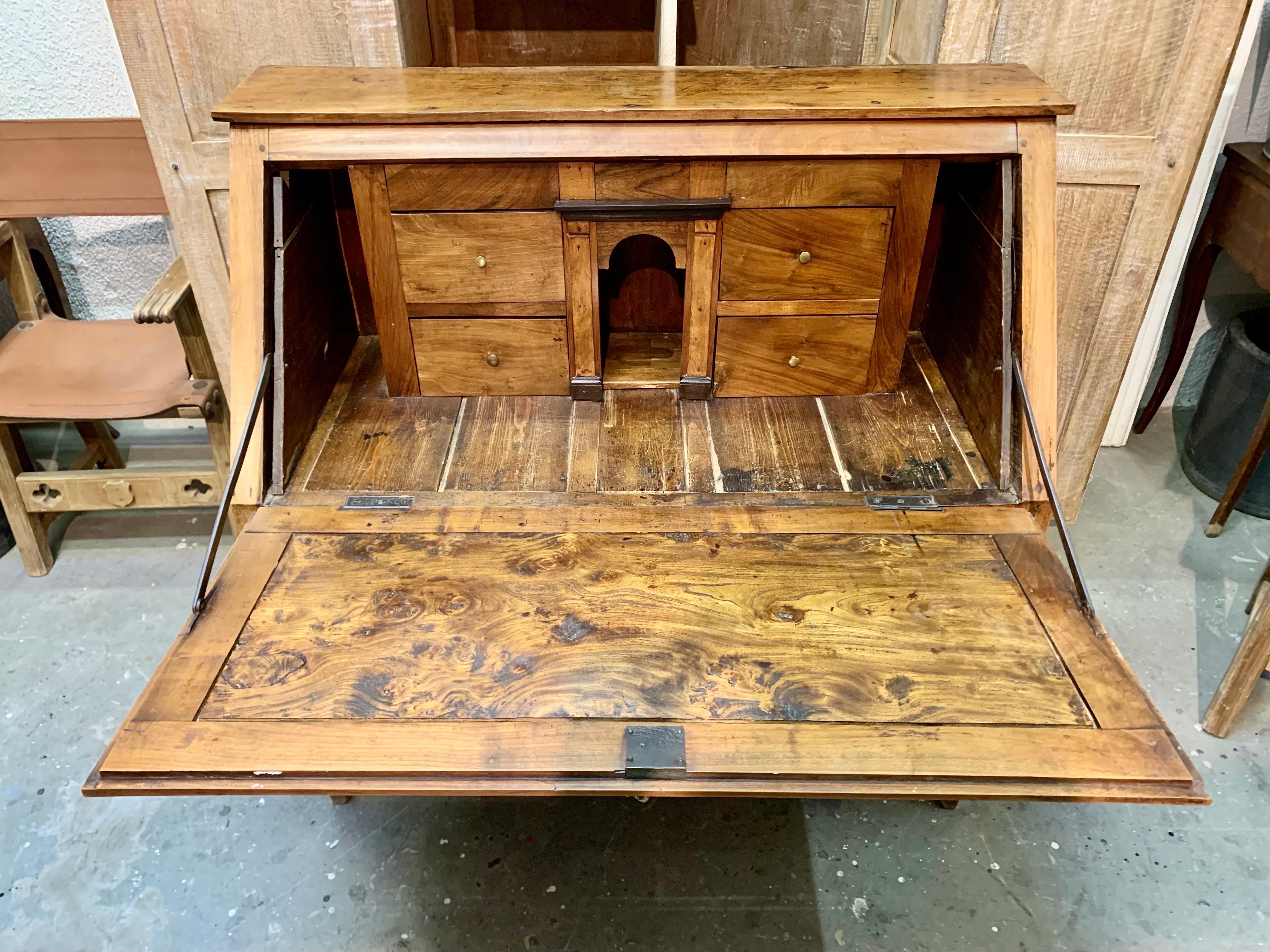 A French Directory era secretary desk, from the early 19th century, made of beautiful cherry wood, in a light tone with bronze handles and bronze keyholes as well. In their lower part they have a long drawer, and two smaller upper ones. When opening