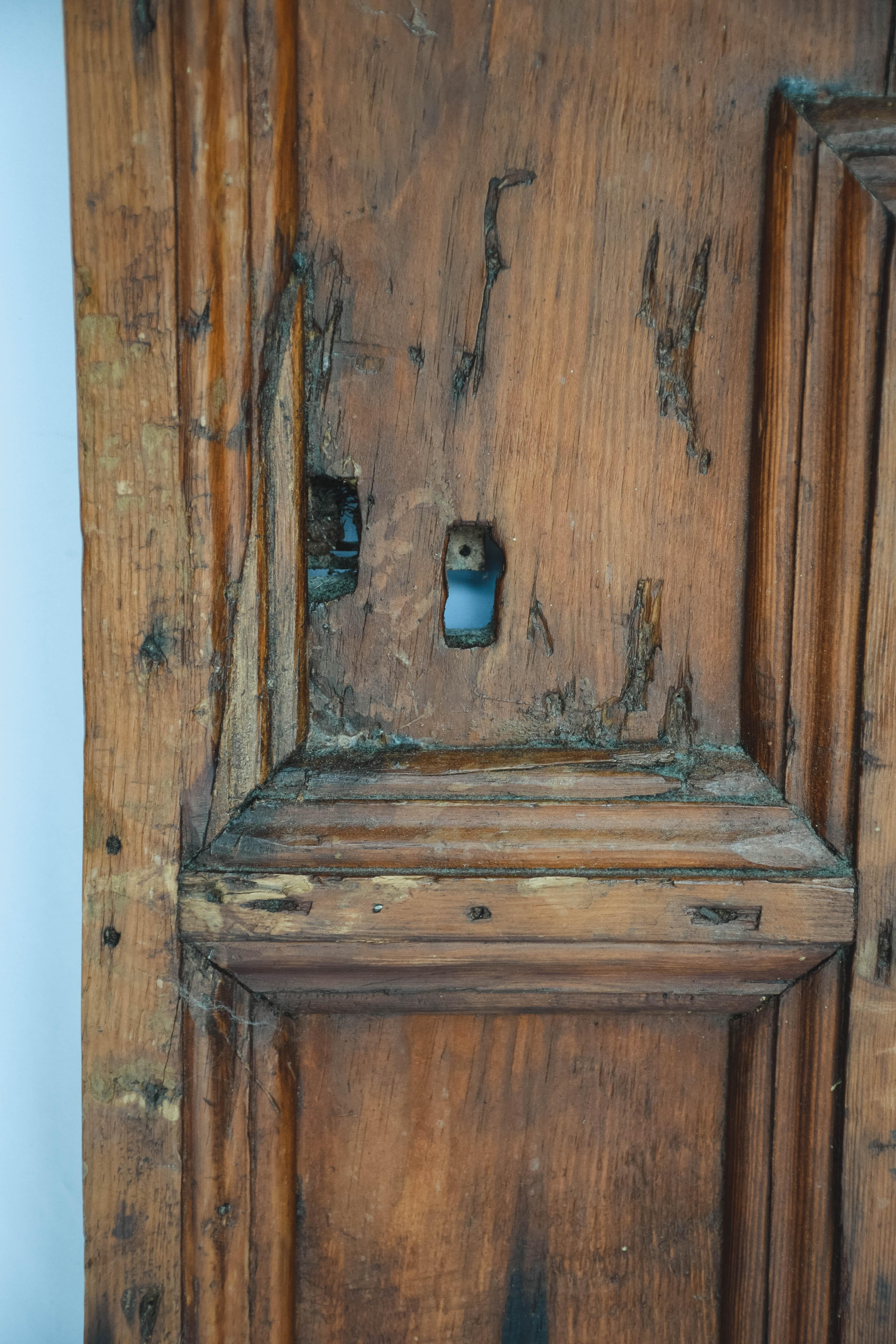 This is a French door form the 19th century. Strong and sturdy the door features hand forged iron hinges and the remnants of a lock. A wonderful piece to use in your home as a cabinet door or simply lean against a wall as a piece of art.
