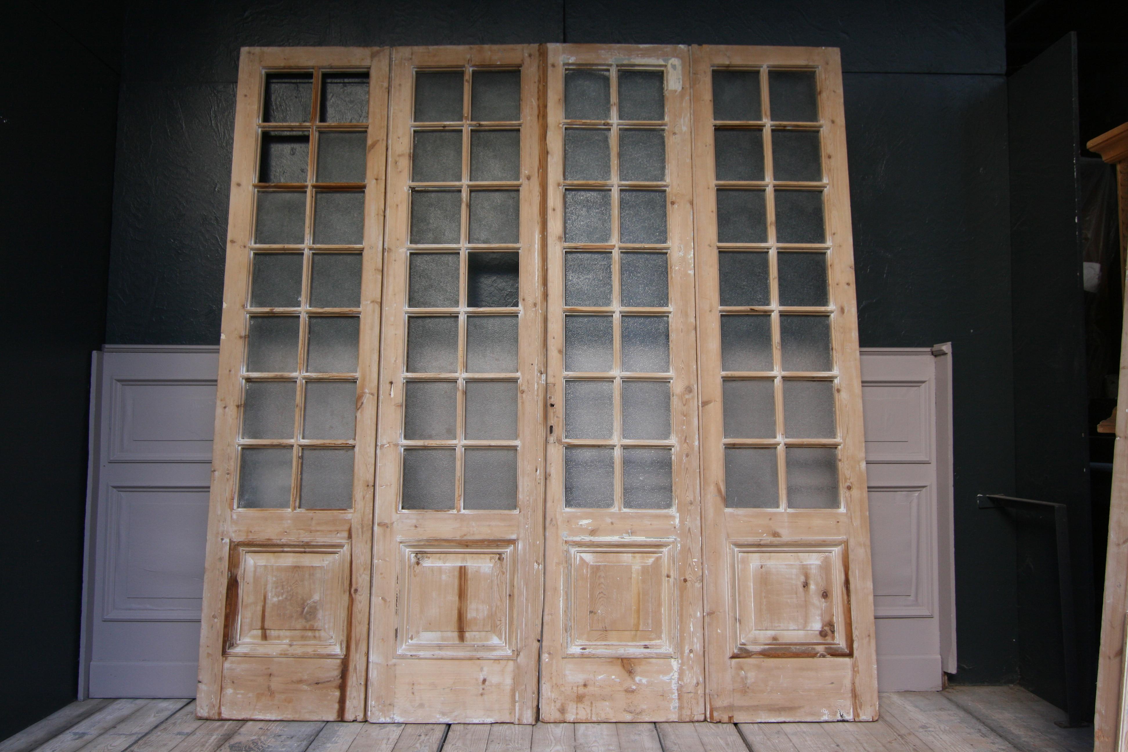 A set consisting of 7 late 19th century French doors made of pine. 
There are 2 pairs of double doors, 2 side panels and another door.
The doors are in unrestored condition.

Dimensions:
246 cm high or 96.85 inch high,
57 cm / 60 cm wide or 22.44 /