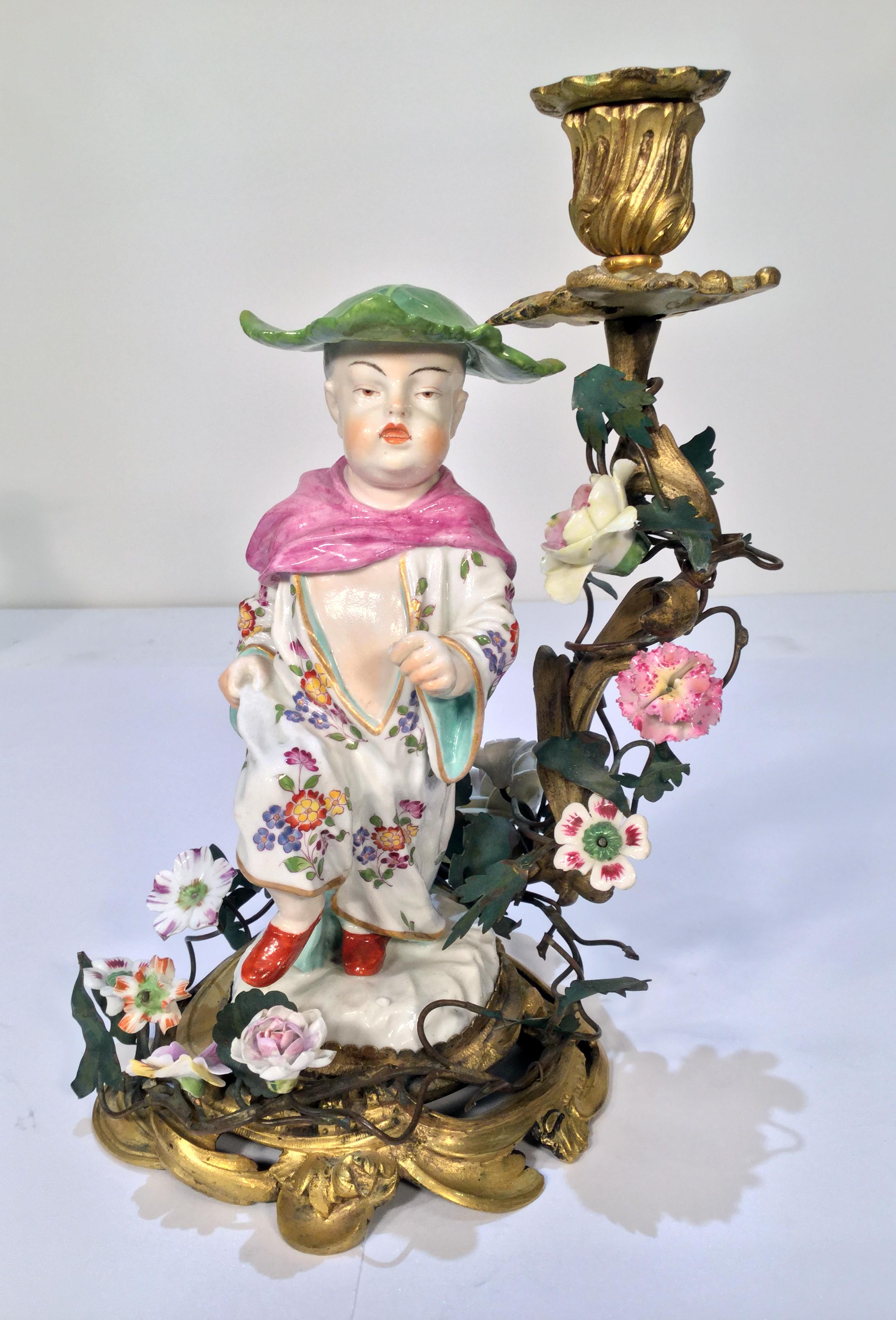 Wonderful opposing French bronze doré candlesticks mounted with German porcelain chinoiserie figures.
