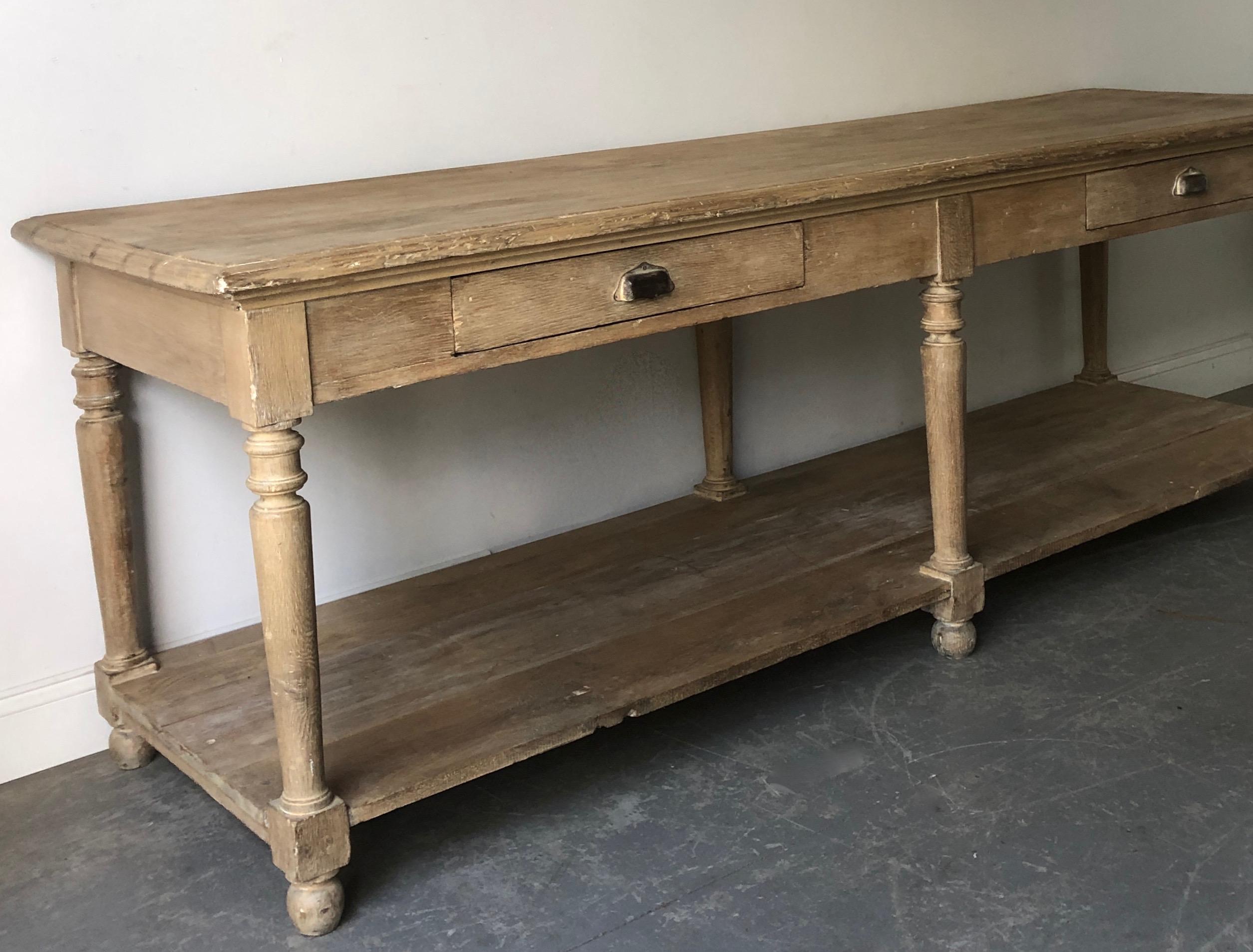 Large 19th century French drapery table with two large drawers, baluster columns und length of the table undertier shelf is a great place for storage -- supporting of six ball legs.
More than ever, we selected the best, the rarest, the unusual, the