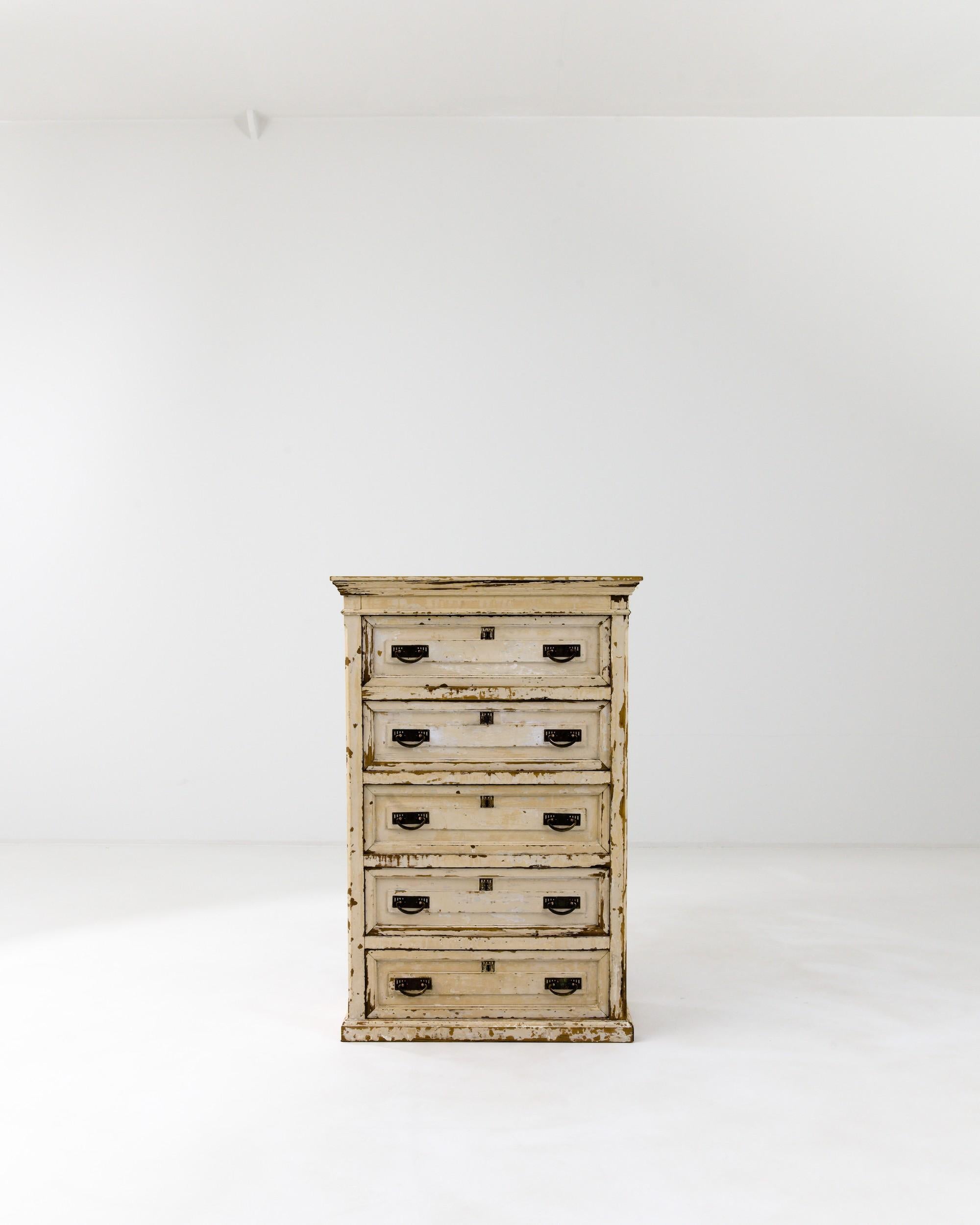 Resting solidly on its plinth base, this 19th-century French chest showcases five drawers equipped with bail pulls with rectangular backplates and square lock pieces.  The molded top accentuates the impeccable geometry of the bureau, while a gently