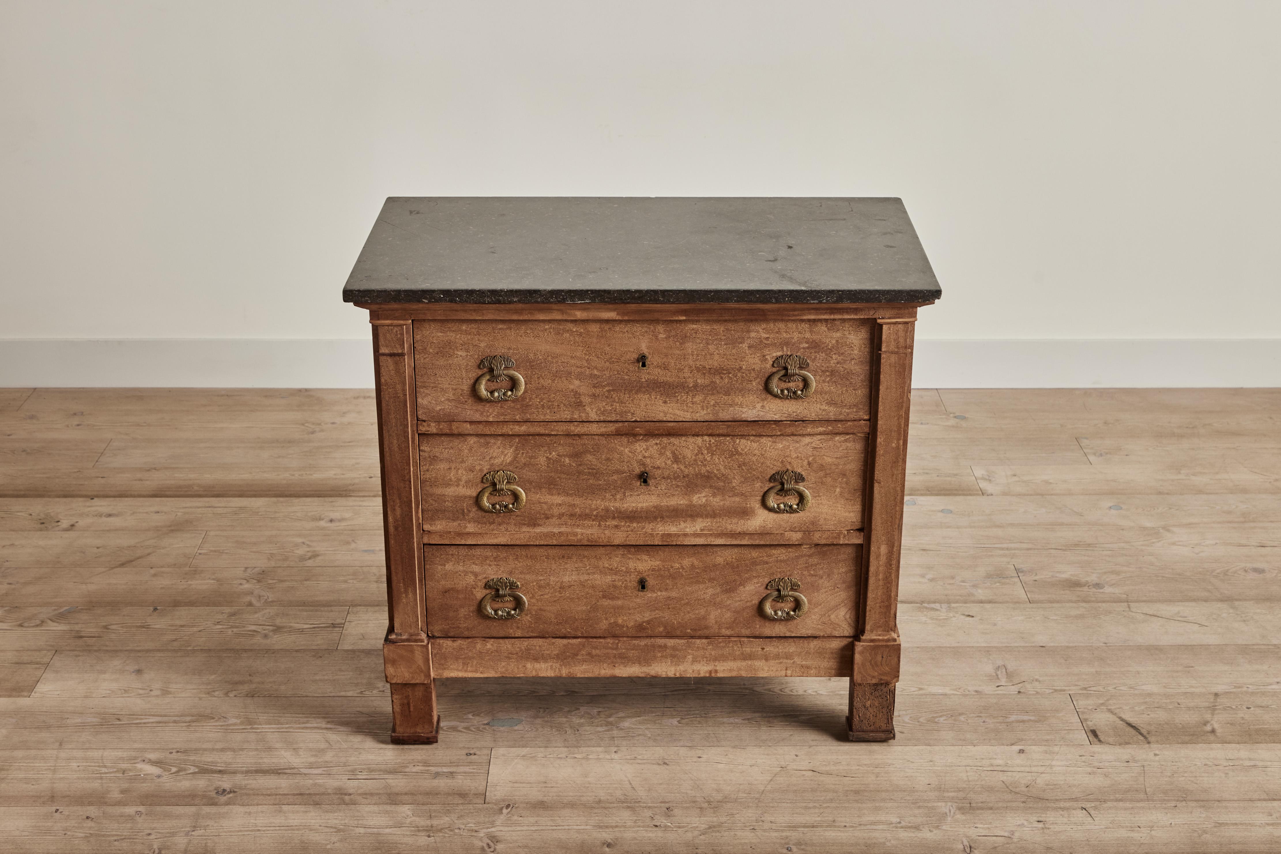Nineteenth century marble top three drawer dresser from France. This dresser has distressed wood with a simple lines and raw finish. Wear throughout is consistent with age and use. 