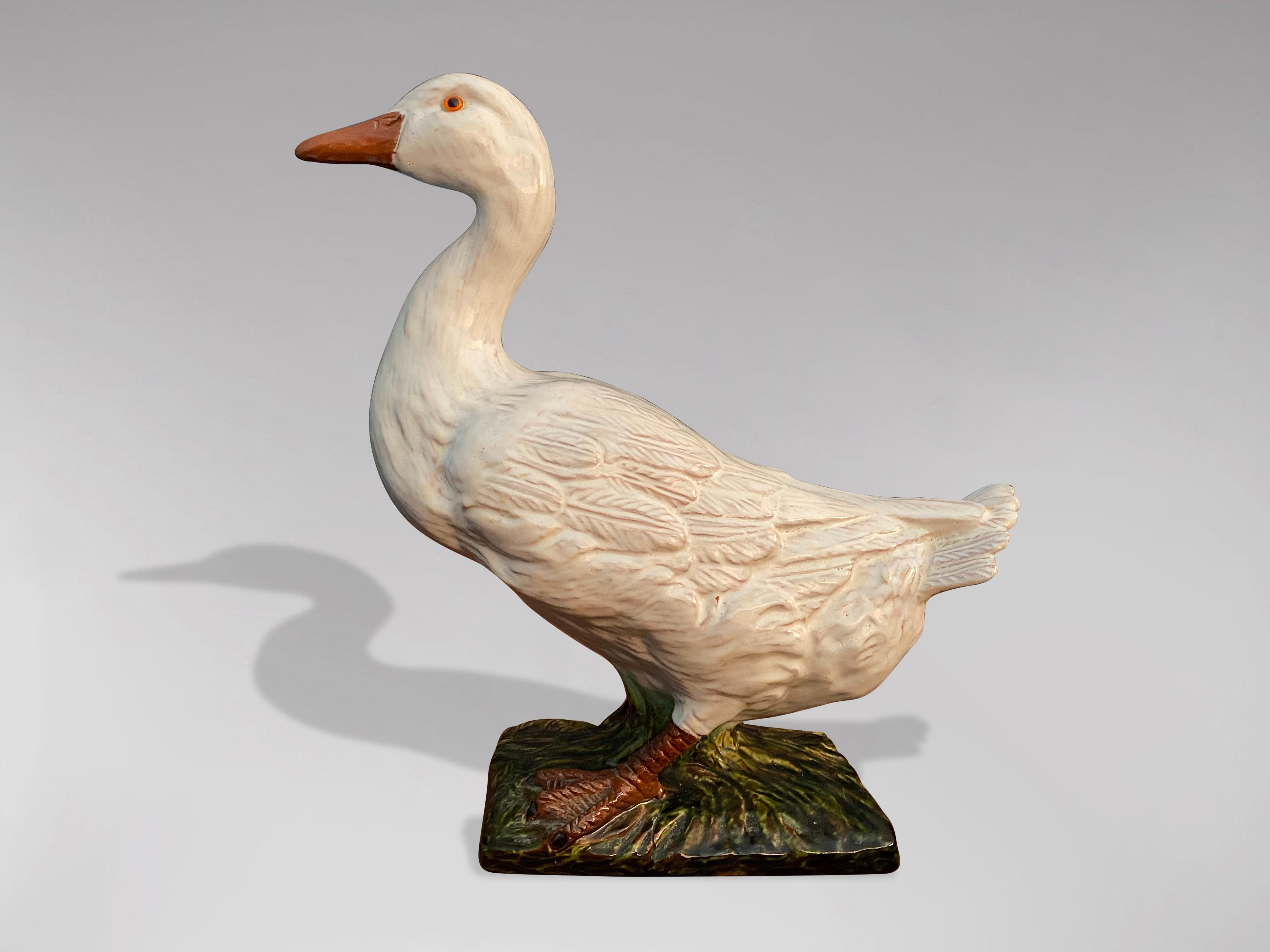 A great looking late 19th century French duck sculpture in earthenware from Bavent in Normandy. The duck of different shades and colours, whites and greens as well as its expressive look testifies to the quality of its craftsmanship. In perfect and