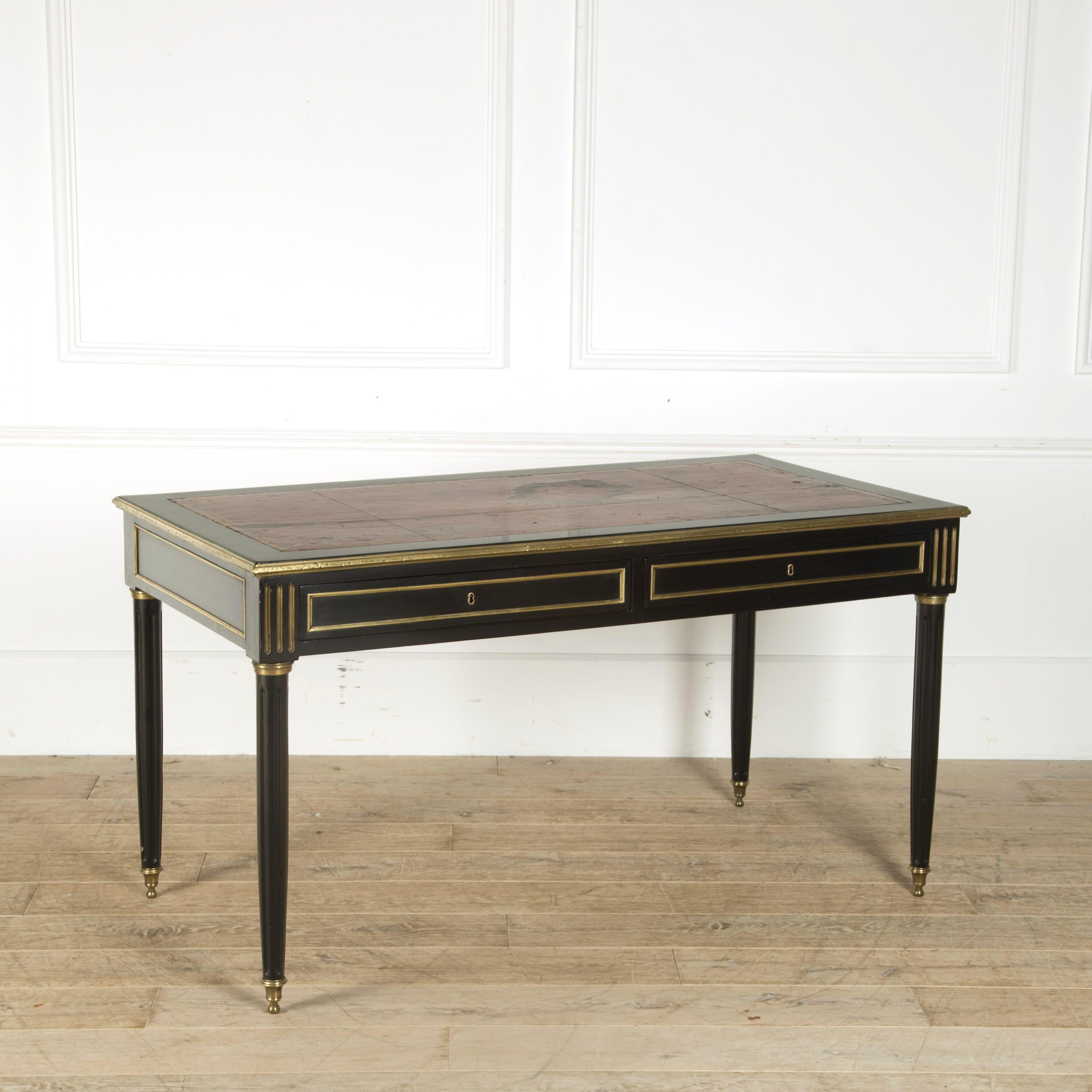 19th century French ebonised bureau plat with brass mouldings, fluted legs and nicely worn original leather top.