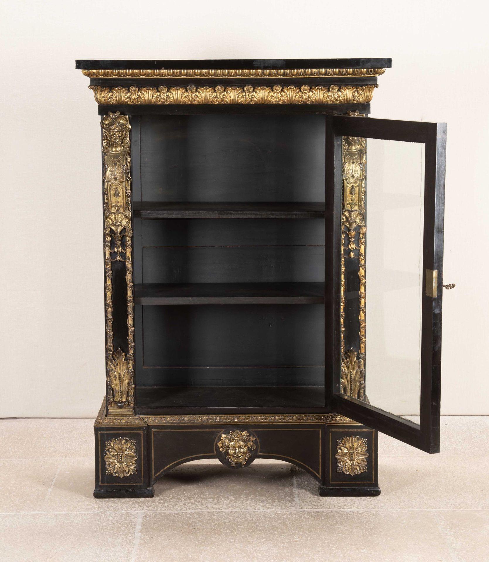 19th Century French ebonised cabinet with outstanding gilt bronze decoration.In the Napoleonic style with gilt bronze mask of Bacchus on the the base, acanthus leaf repeat decoration along with egg and dart and vines on the side panels. Below, the