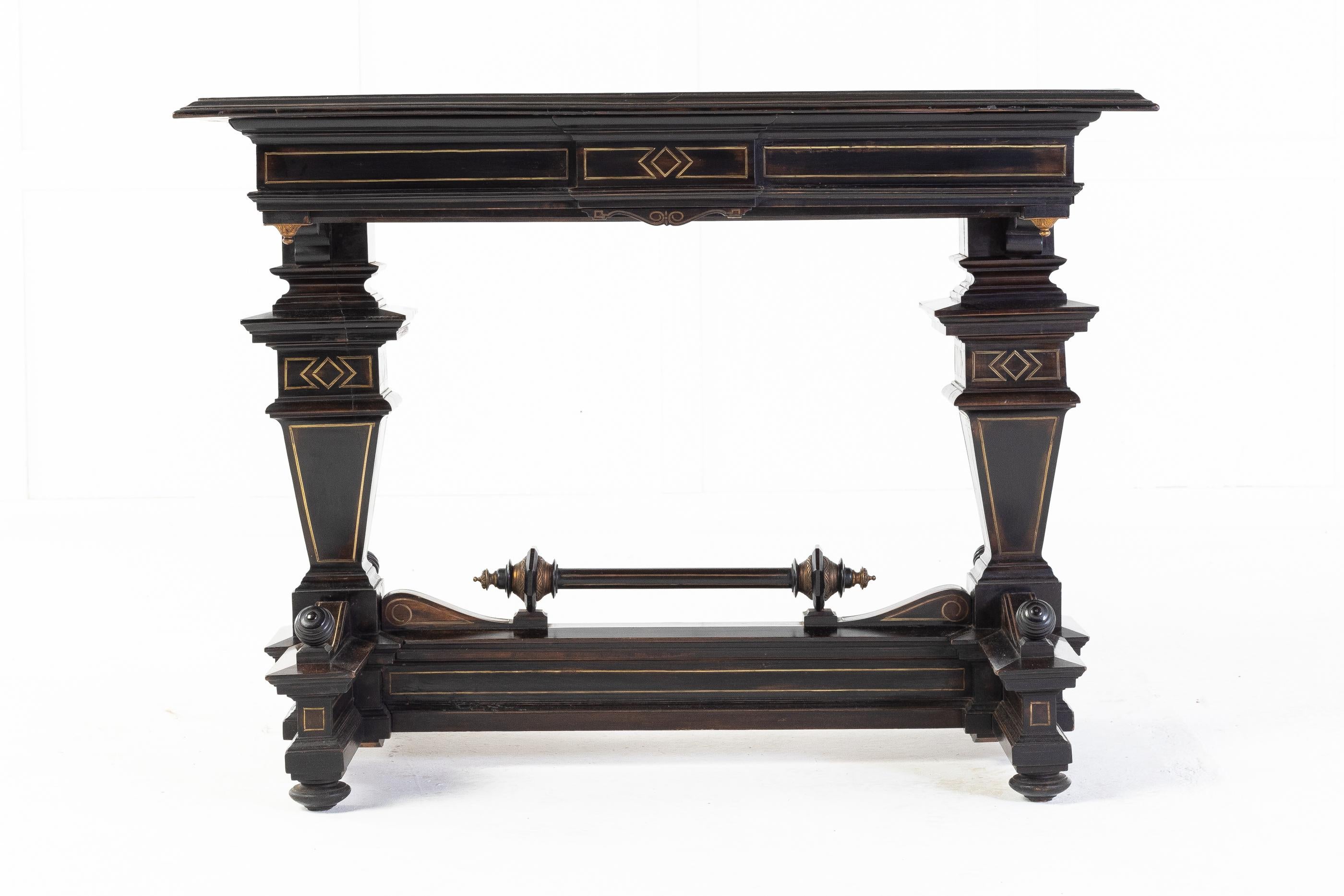 Very unusual 19th century French ebonised side table. This unusual design has many mouldings each inlaid with brass to highlight the mouldings. The top, also with brass inlay sits above a frieze with a single long drawer. Two unusual supports are