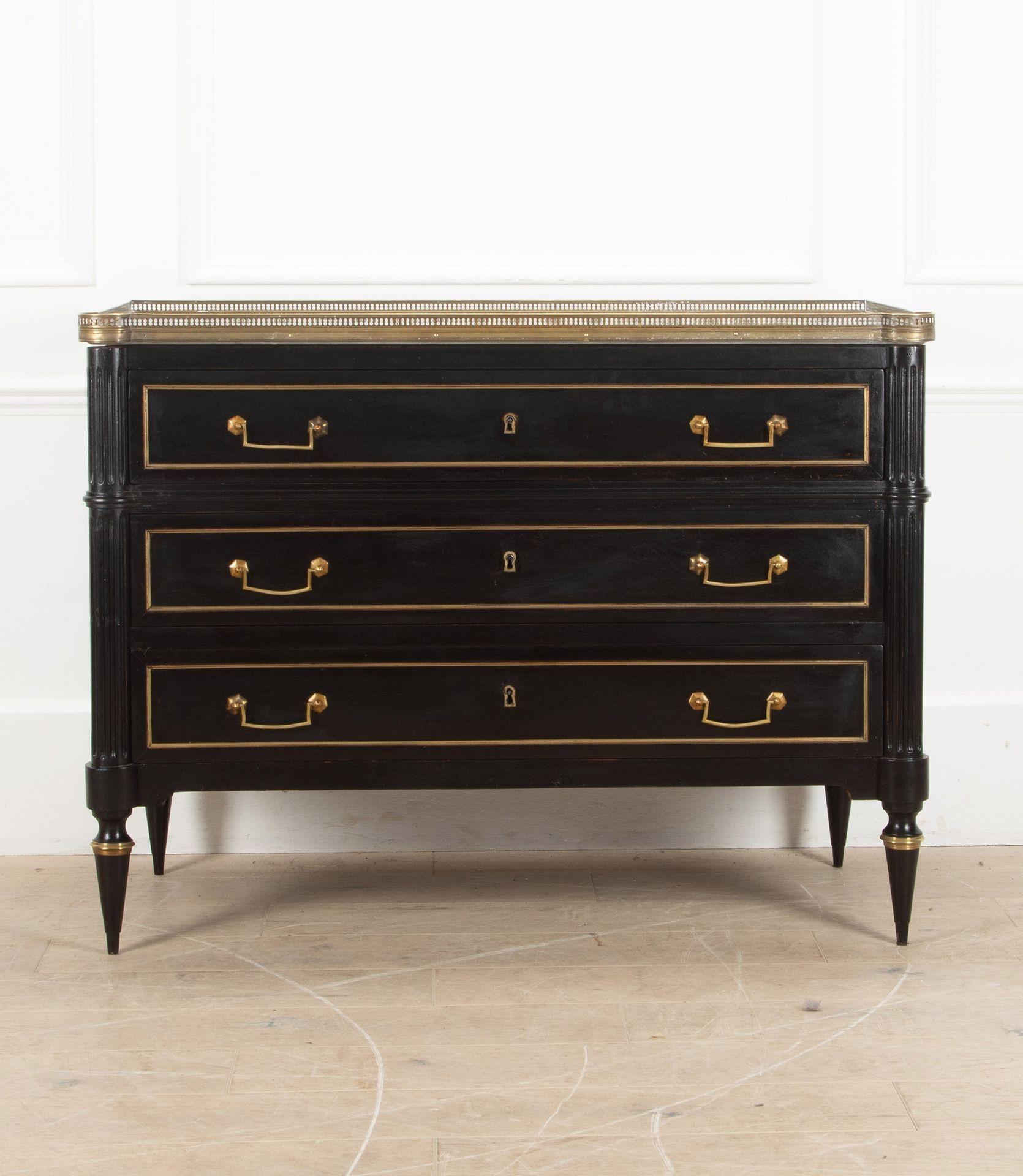 A Louis XV ebonised, three drawer commode.
With marble top and brass gallery.
France, Circa 1850.