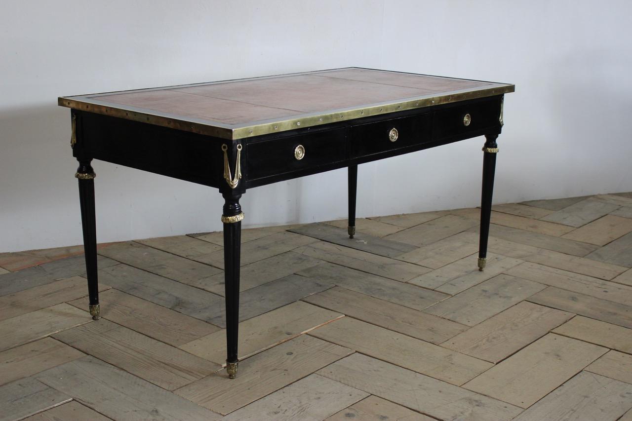 A very elegant, 19th century Fresh double-sided ebonized desk with bronze mounts, and three drawers, retaining the original leather top. 
Measurements: 59cm high (knee height) 
France.