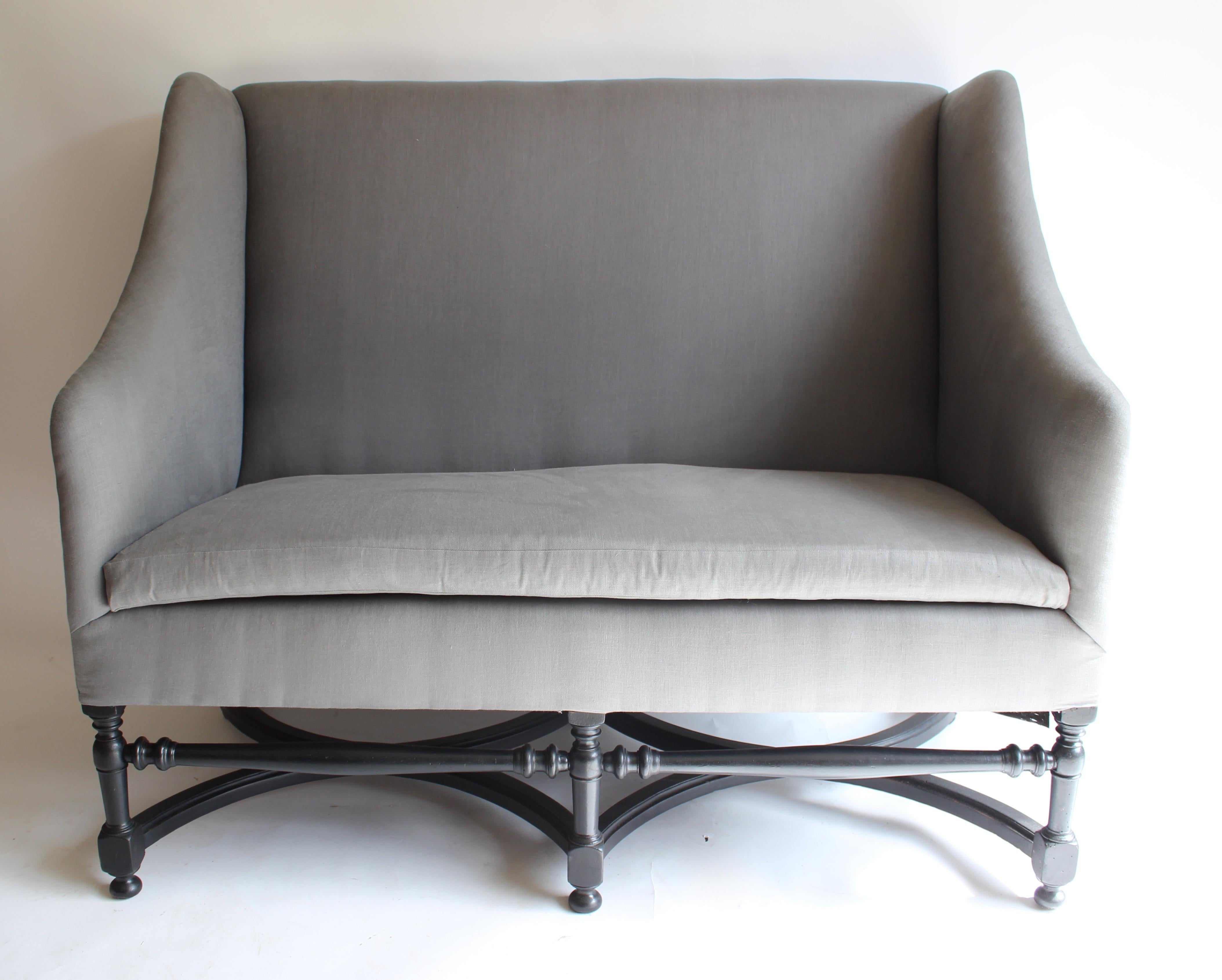 19th century French ebonized wood settee. Newly upholstered.