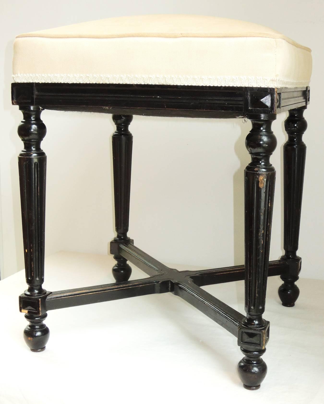 Napoleon III ebonized stool. Bought in France.
References Louis XVI style with the fluted legs and trim, set off by corner elements, and balls top and bottom.