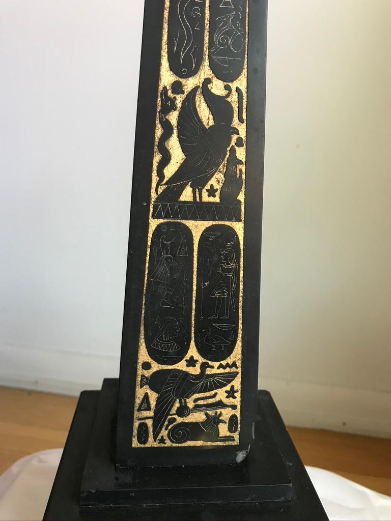 19th century Grand Tour / Egyptian Revival carved and polished black slate obelisk, the fronts decorated with very fine incised hieroglyphic designs which have been accented with gold leaf. The obelisk is raised on a stepped base with incised