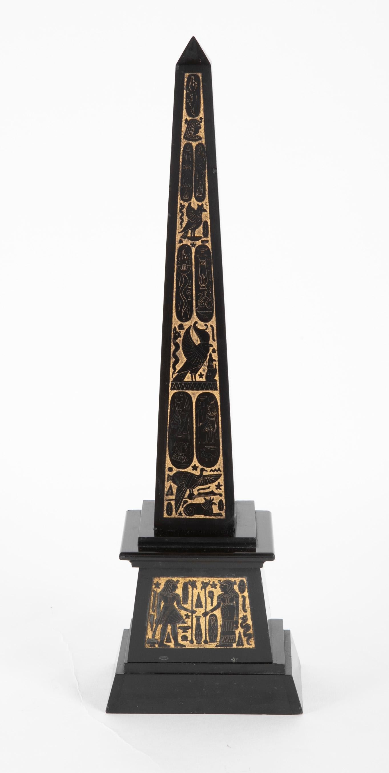 19th century Grand Tour Egyptian Revival carved and polished black slate obelisk, the front decorated with very fine incised hieroglyphic designs which have been accented with gold leaf. The obelisk is raised on a stepped base with incised details.