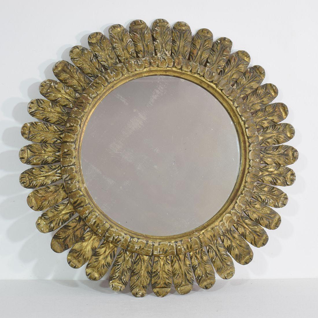 An elegant gilt carved wood circular feather mirror
France, 19th century. Weathered, small losses.

 
  