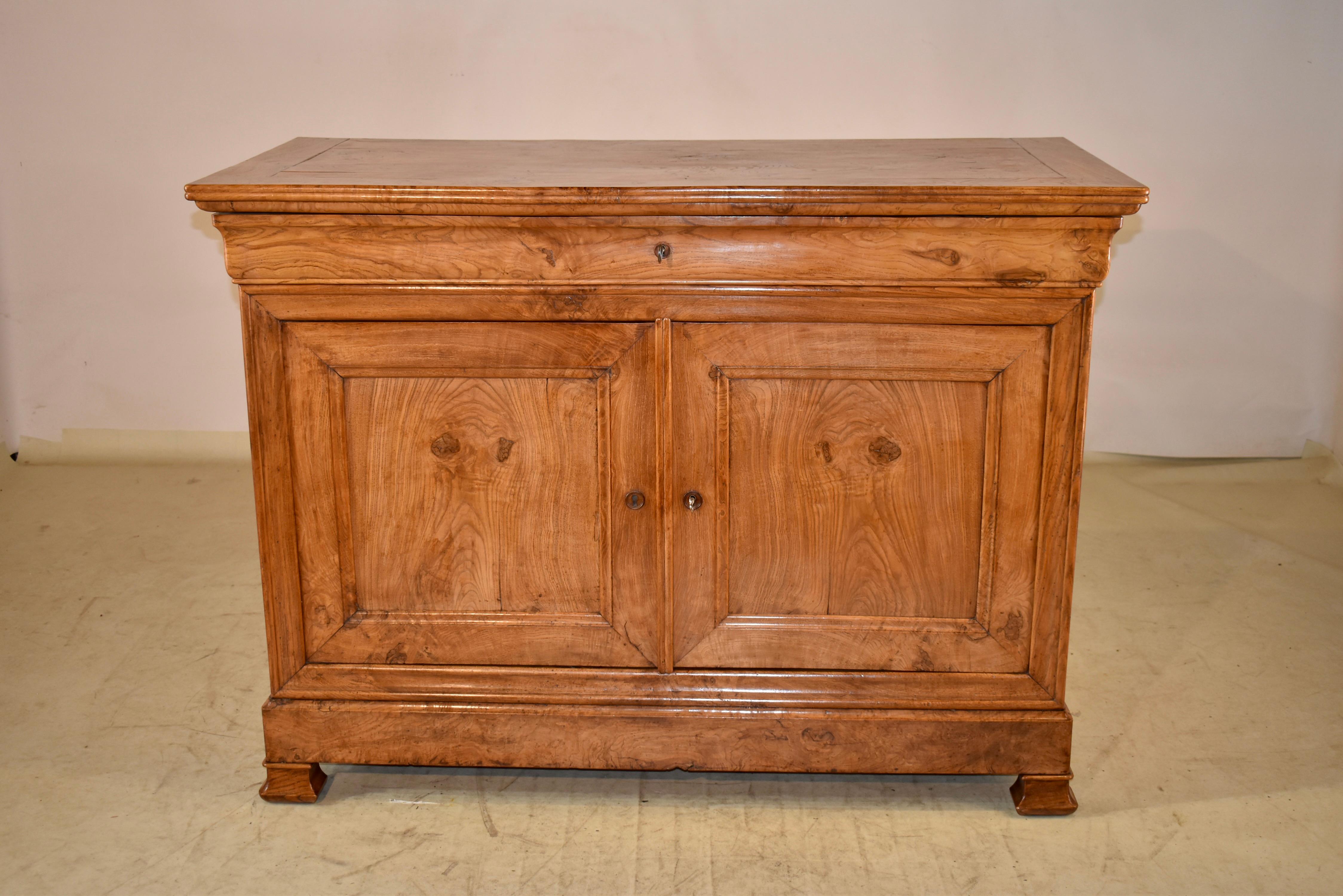 19th century elm buffet from France.  The top is made from exquisitely grained burl elm, and is banded in the same, for a stunning top perspective.  The sides are paneled and feature burl elm panels as well for an interesting design feature on the