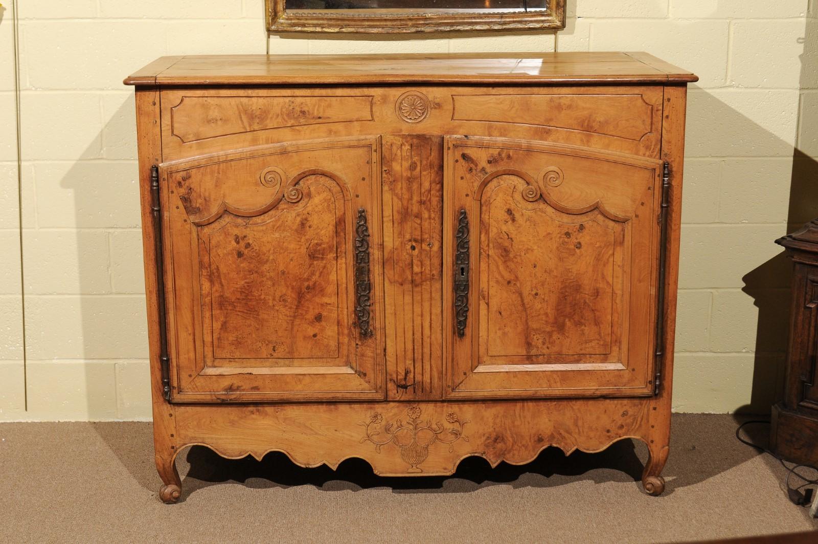 19th Century French elm buffet with flower & urn carving, shaped apron, & cabriole feet.