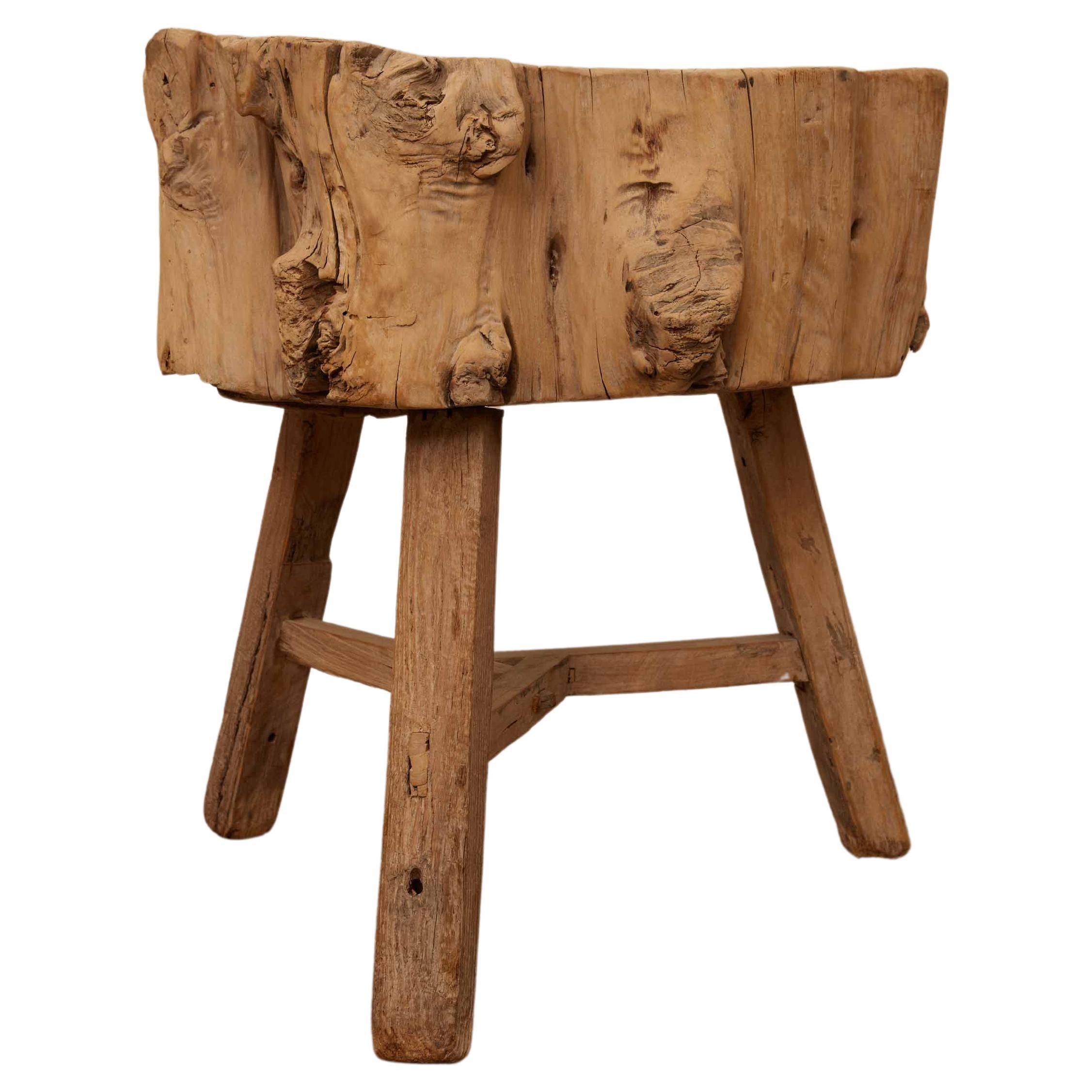  19th Century French Elm Chopping Block Table that exudes rustic charm and authenticity. Crafted from a single, robust stump of natural elm wood, this piece stands as a testament to the timeless beauty and durability of traditional materials.

The