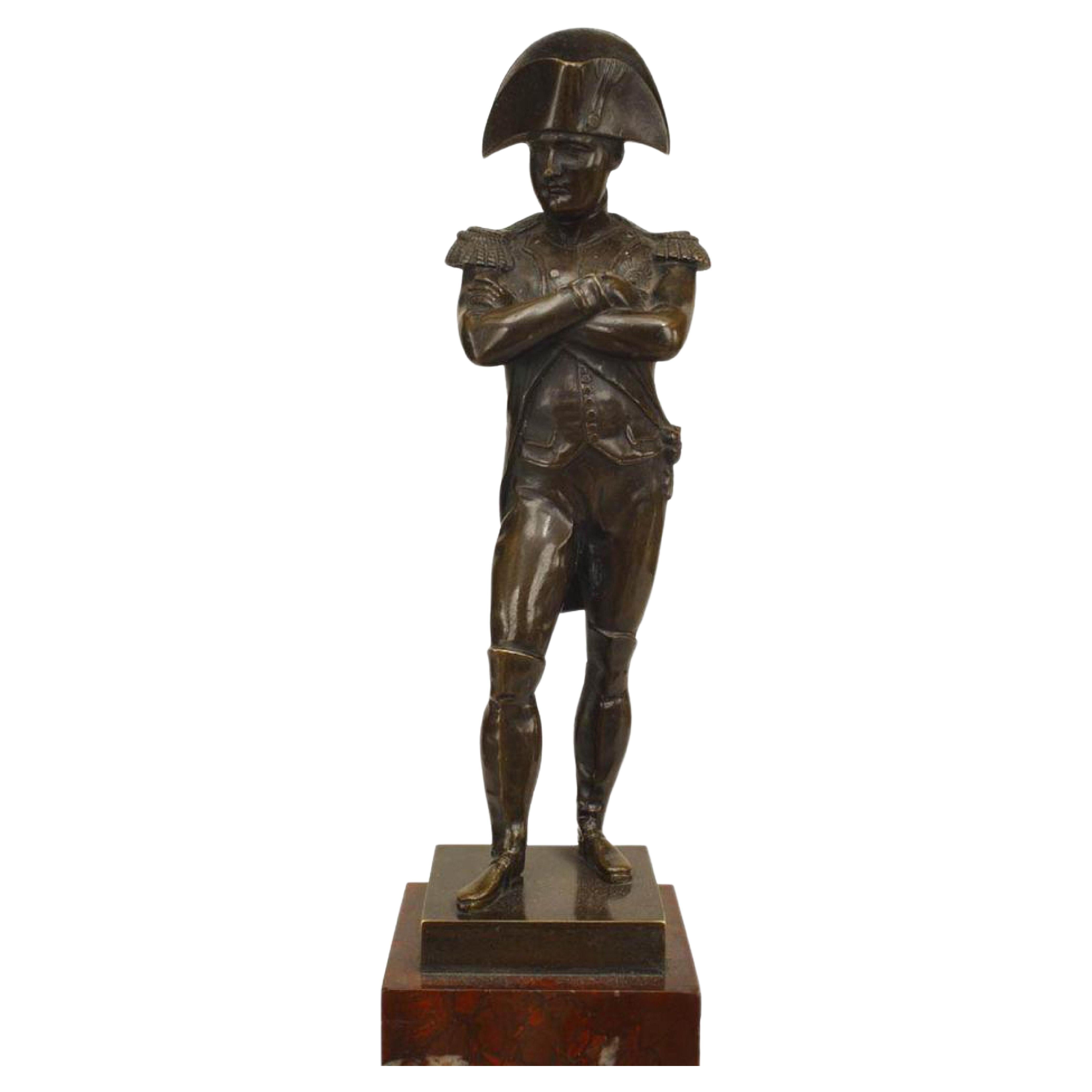 French Empire style (19th Century) bronze figure of Napoleon standing with arms crossed on rouge marble pedestal base with bronze trim.
 