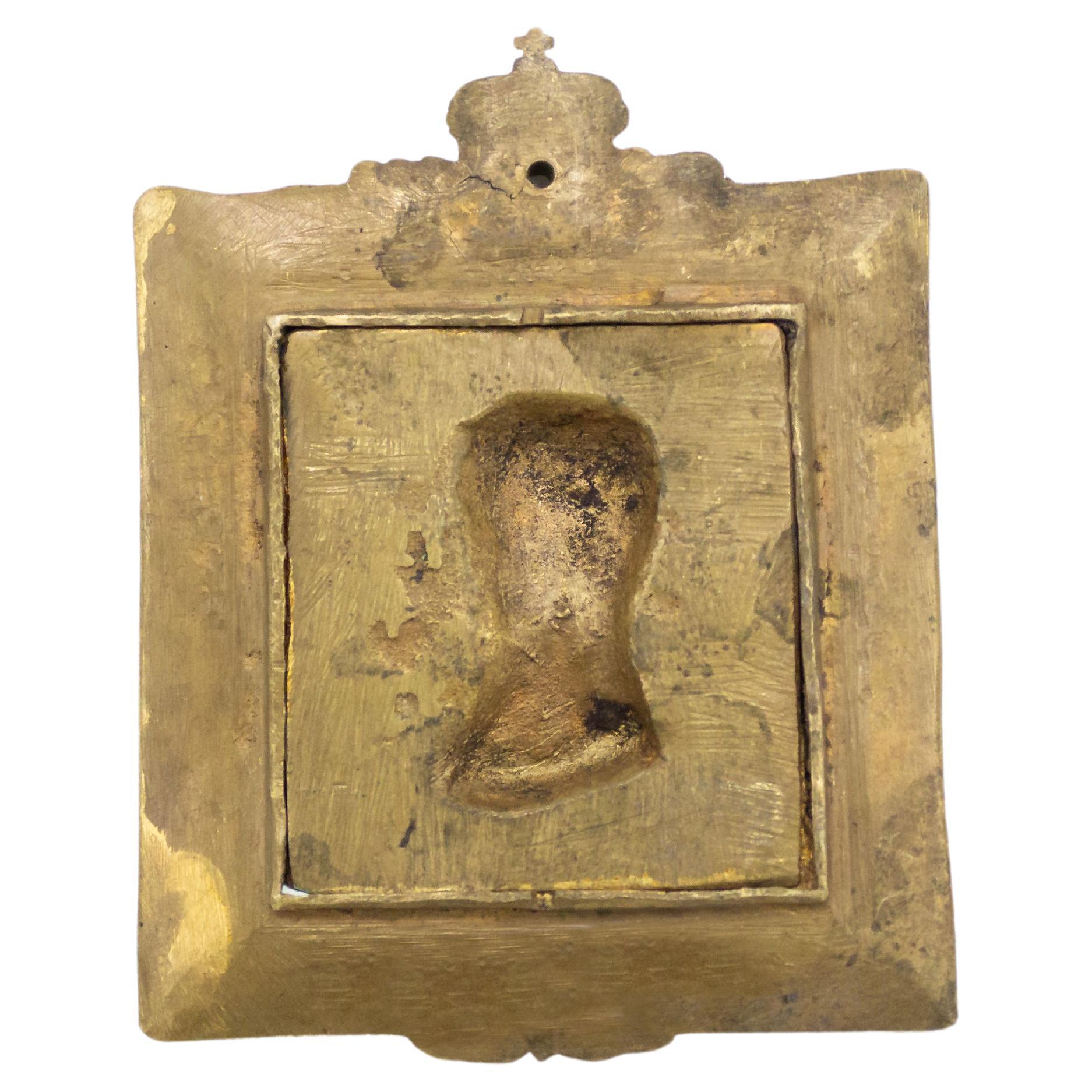 French Empire style (19/20th Cent) bronze miniature plaque of a bust of Napoleon in relief set inside a matching design frame resting on an easel stand.
 