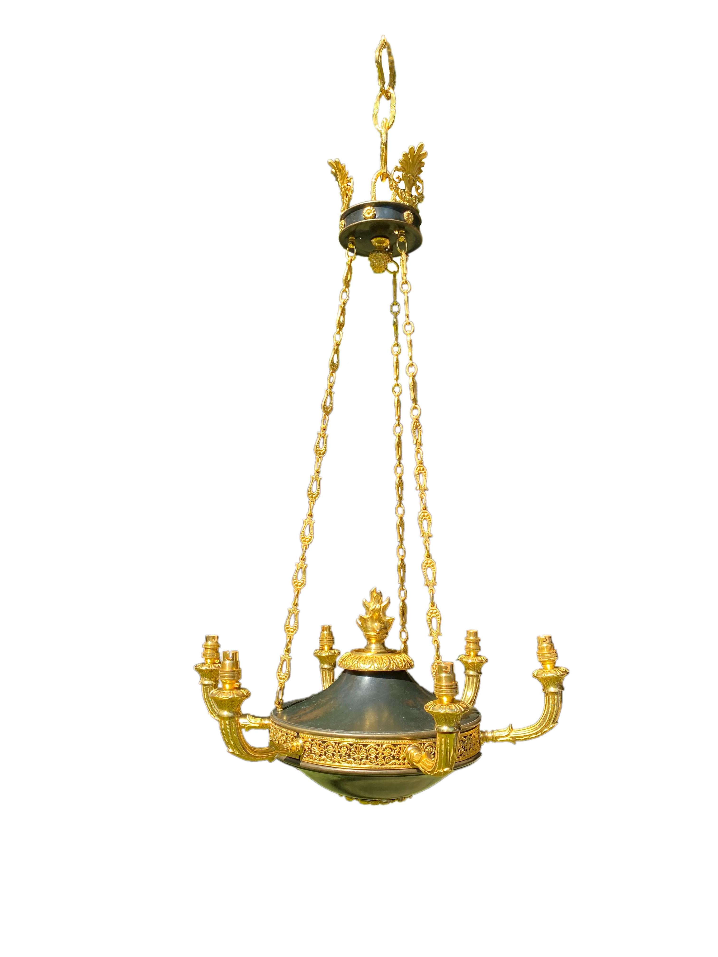 Splendid late 19th century French Empire gilt bronze and tole chandelier having a coronet with chains hanging down to the chandelier that has six branch sconces, and a flame to the centre and classical finial to the upside.