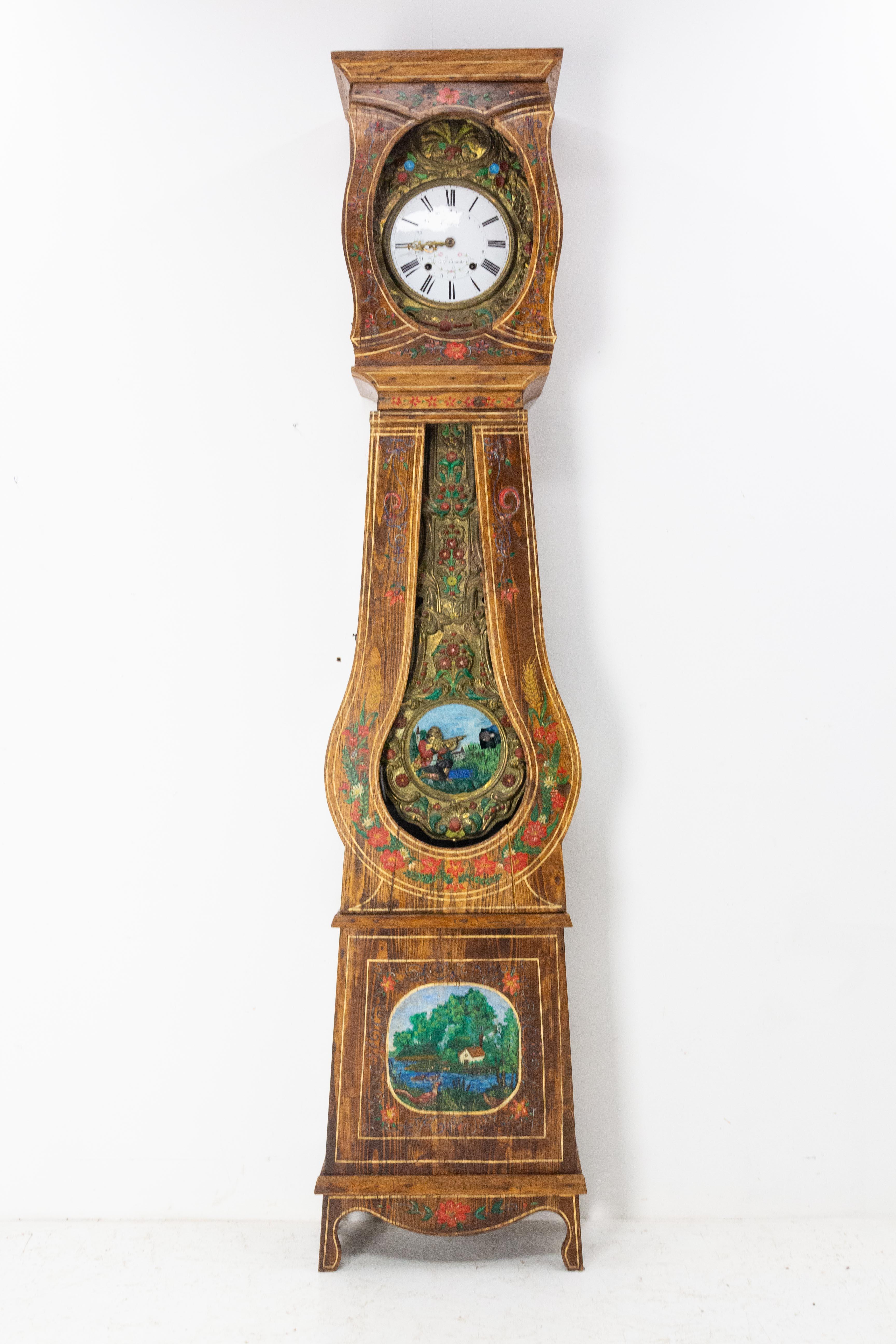 Grandfather clock or Comtoise from South West of France, Gers, late 19th century.
The pendulum and the clock are painted in Rococo style ornamentation.
On the pendulum a hunter in traditional dress aims is represented.
The case is ornate with a