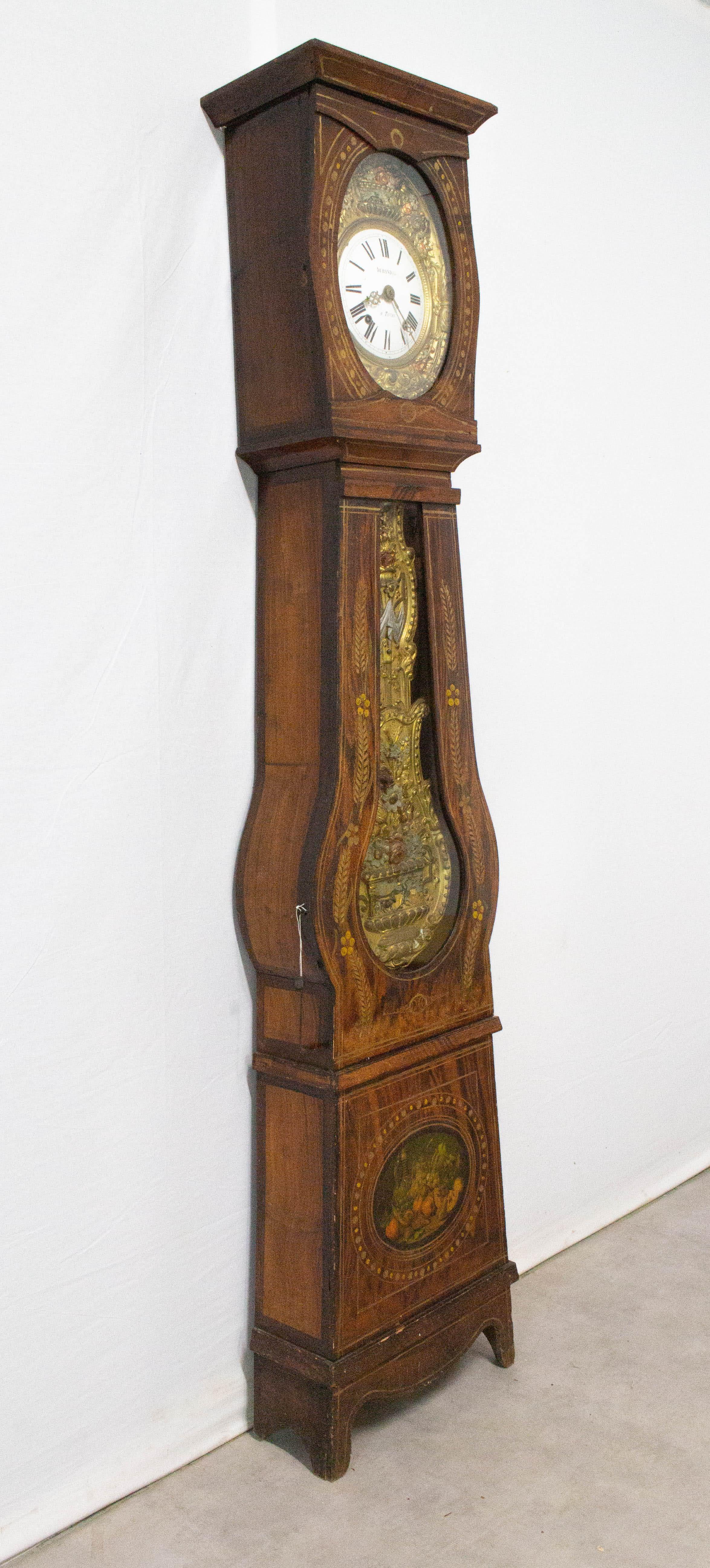 Grandfather clock or Comtoise from South of Bordeaux, France, Empire, 19th century.
The pendulum and clock surround are painted in Rococo style ornamentation, representing farm scenes.
The case with polychrome flower and ears of wheat decoration is