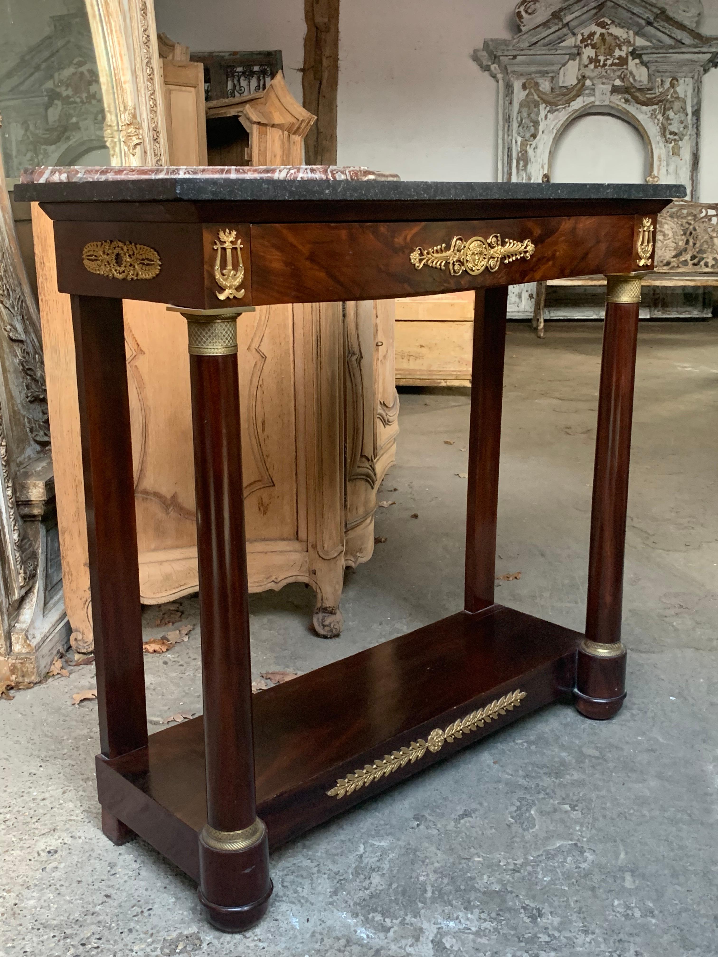 A nice quality 19th century French Empire console table made from flamed Cuban mahogany. With a Belgian bluestone top and original ormolu mounts. Circa 1810.

Please contact us directly for a worldwide shipping quote 