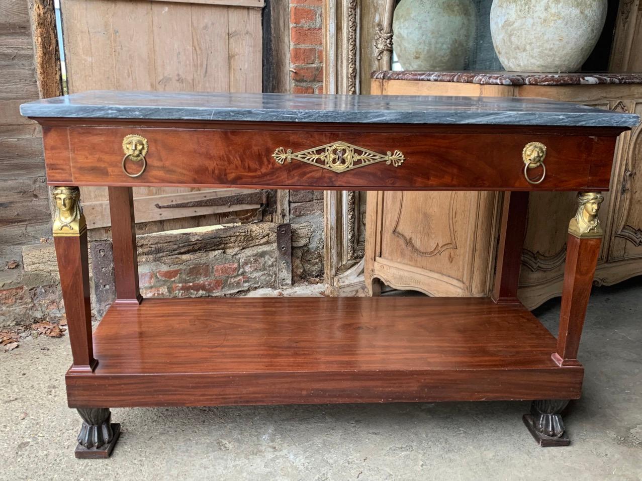 A nice quality French Empire console table made from flame mahogany with original brass ormolu mounts. Original grey marble top and Lion paw feet, with single large drawer at the front.

Please contact us directly for a worldwide shipping quote