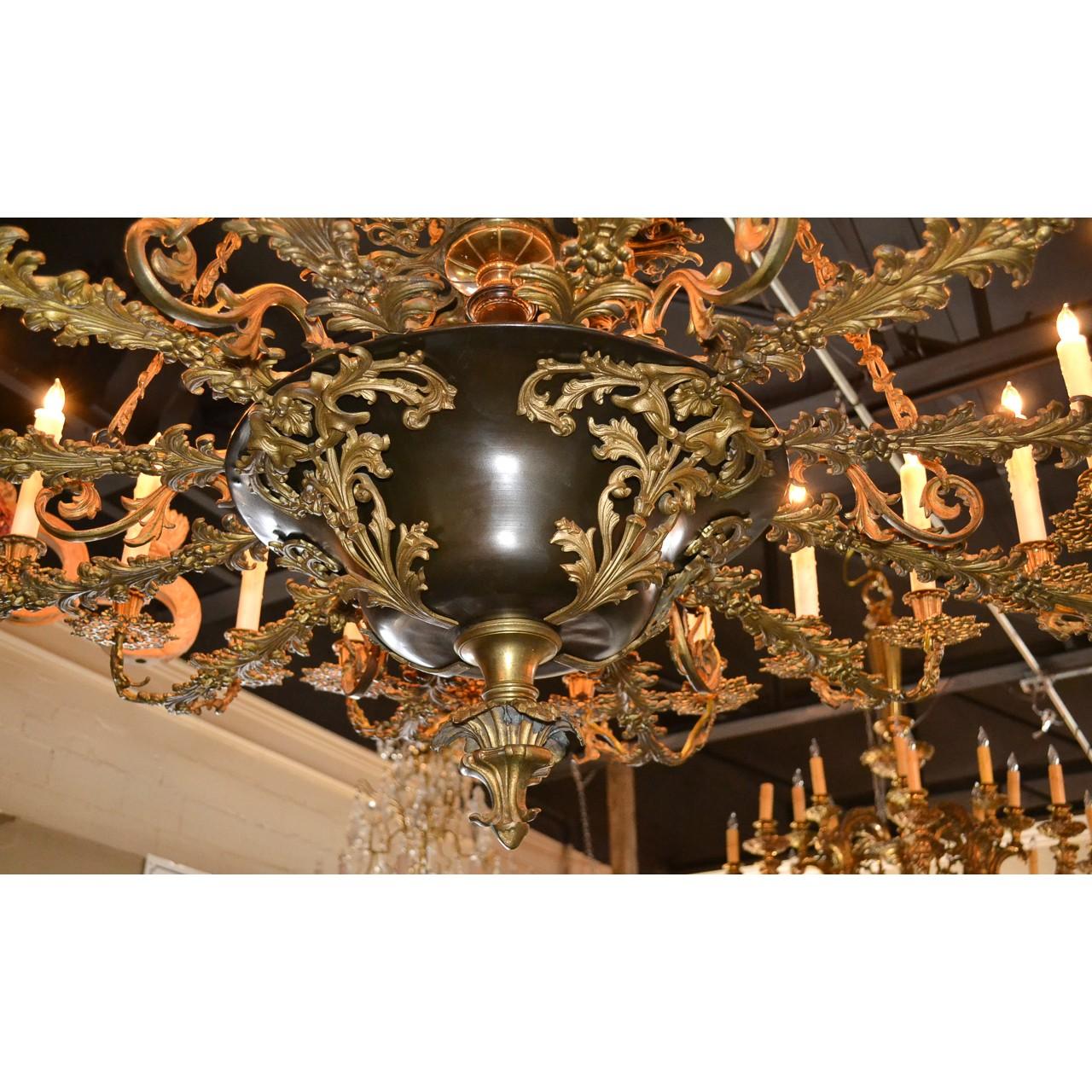 Extraordinary 19th century French bronze twenty-four light chandelier of paragon quality. The bronze scrolling leaf and shell designed canopy holding chains of intertwined vines above finely cast bronze foliate motif arms with leaf spray bobeche.