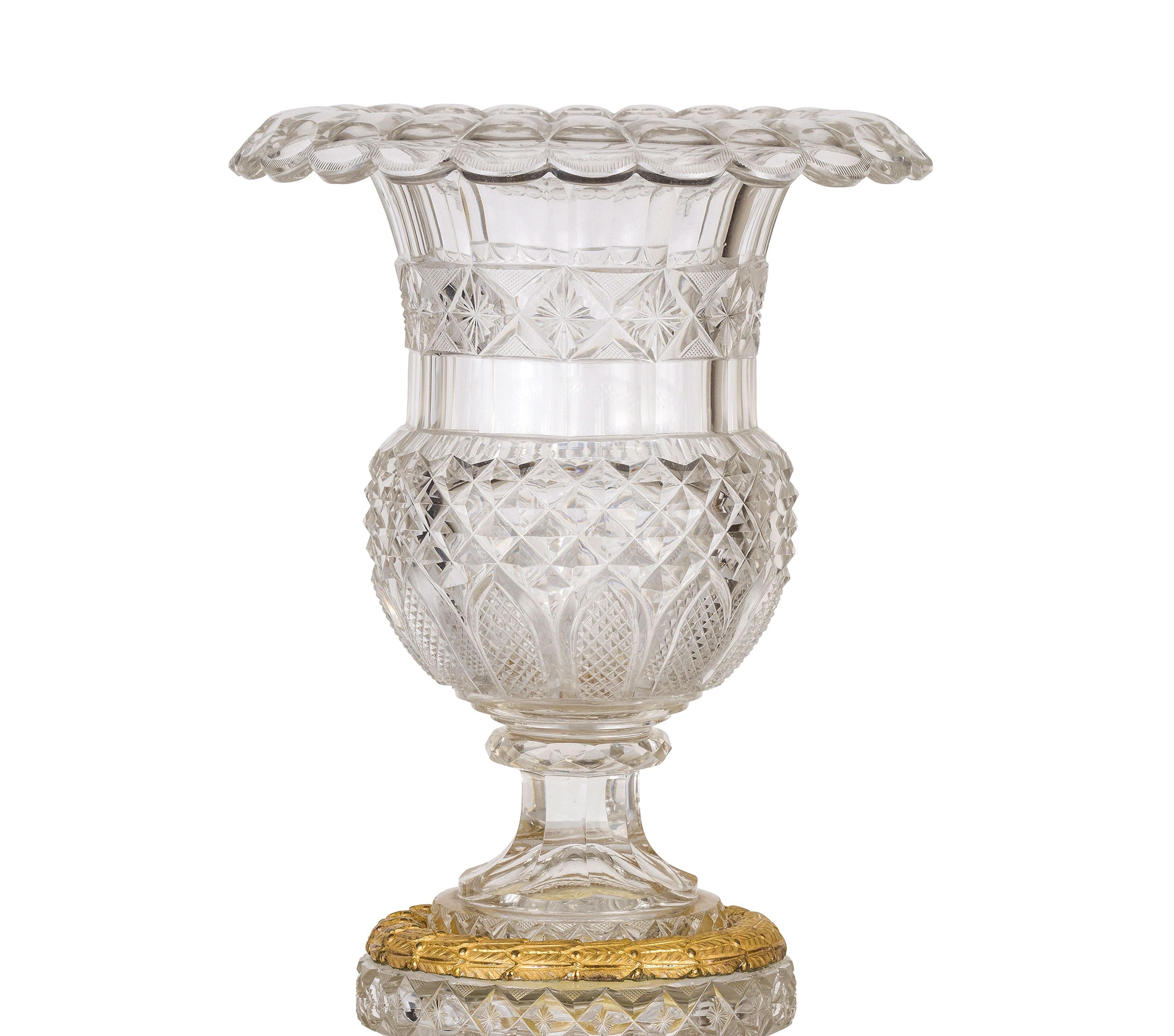 19th century, French Empire ground crystal and gilt bronze vase centrepiece

This Empire centerpiece, made in France at the beginning of the 19th century, consists of a large vase in ground glass resting on a cylindrical elevation with concave