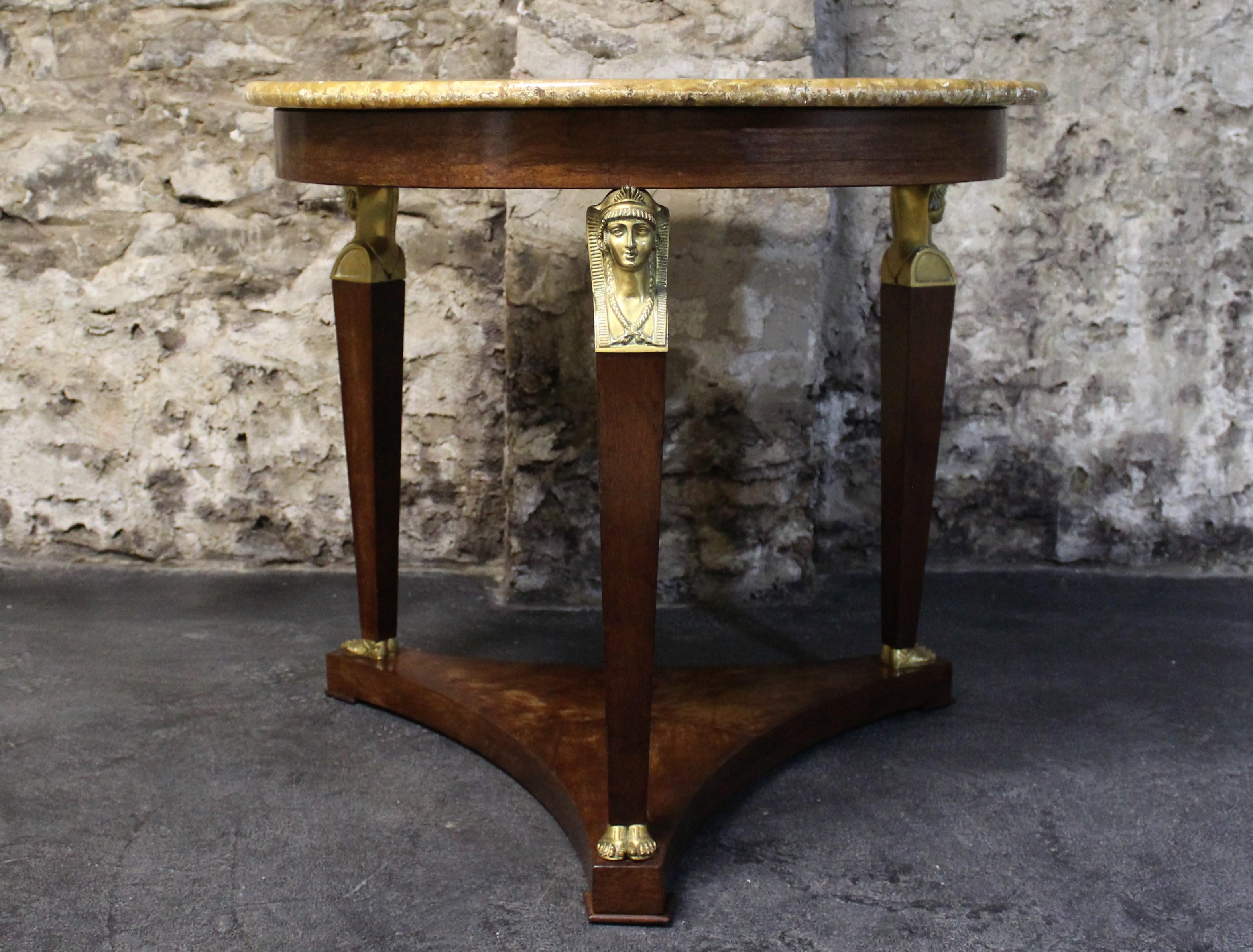 19th century, French Empire mahogany center table with gilt bronze caryatids supporting onyx top.