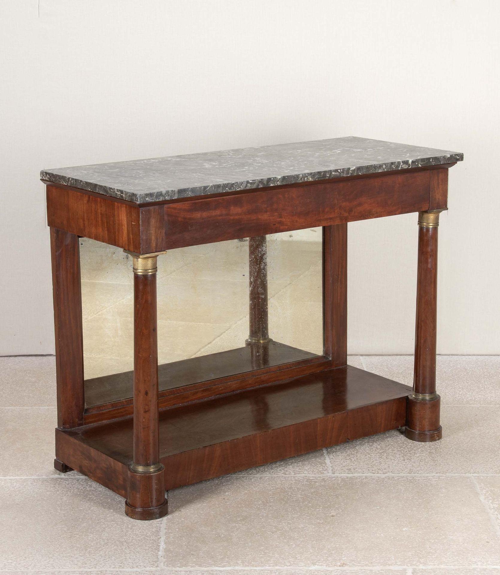19th Century French Empire mahogany console with a variegated black marble top.
Supported by parcel gilt columns, with a mirrored back and under shelf.
Circa 1860.