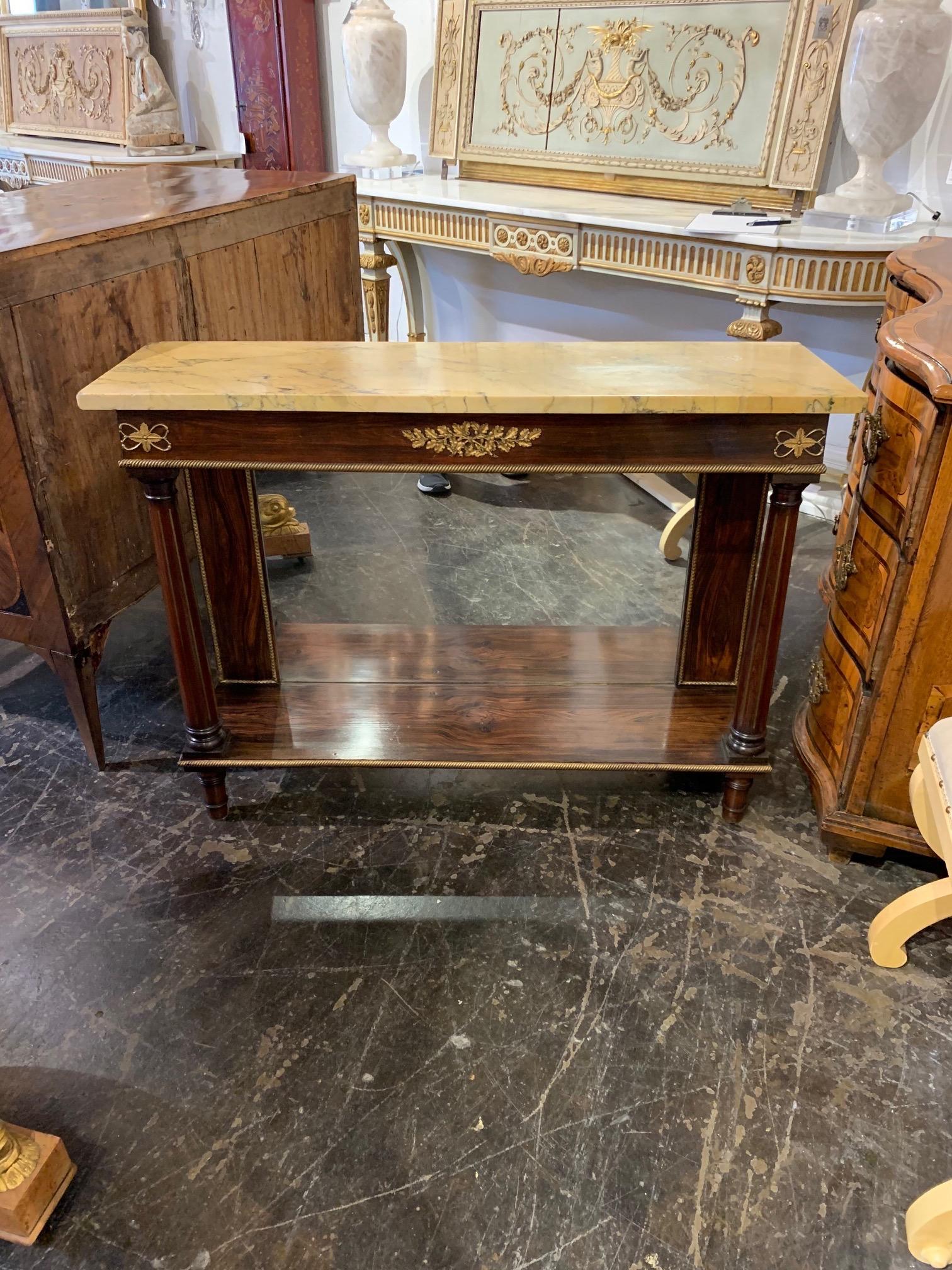 Elegant 19th century French Empire rosewood console with a gorgeous Sienna marble top. The piece has beautiful decorative details including brass trim and a mirrored base. Fabulous!