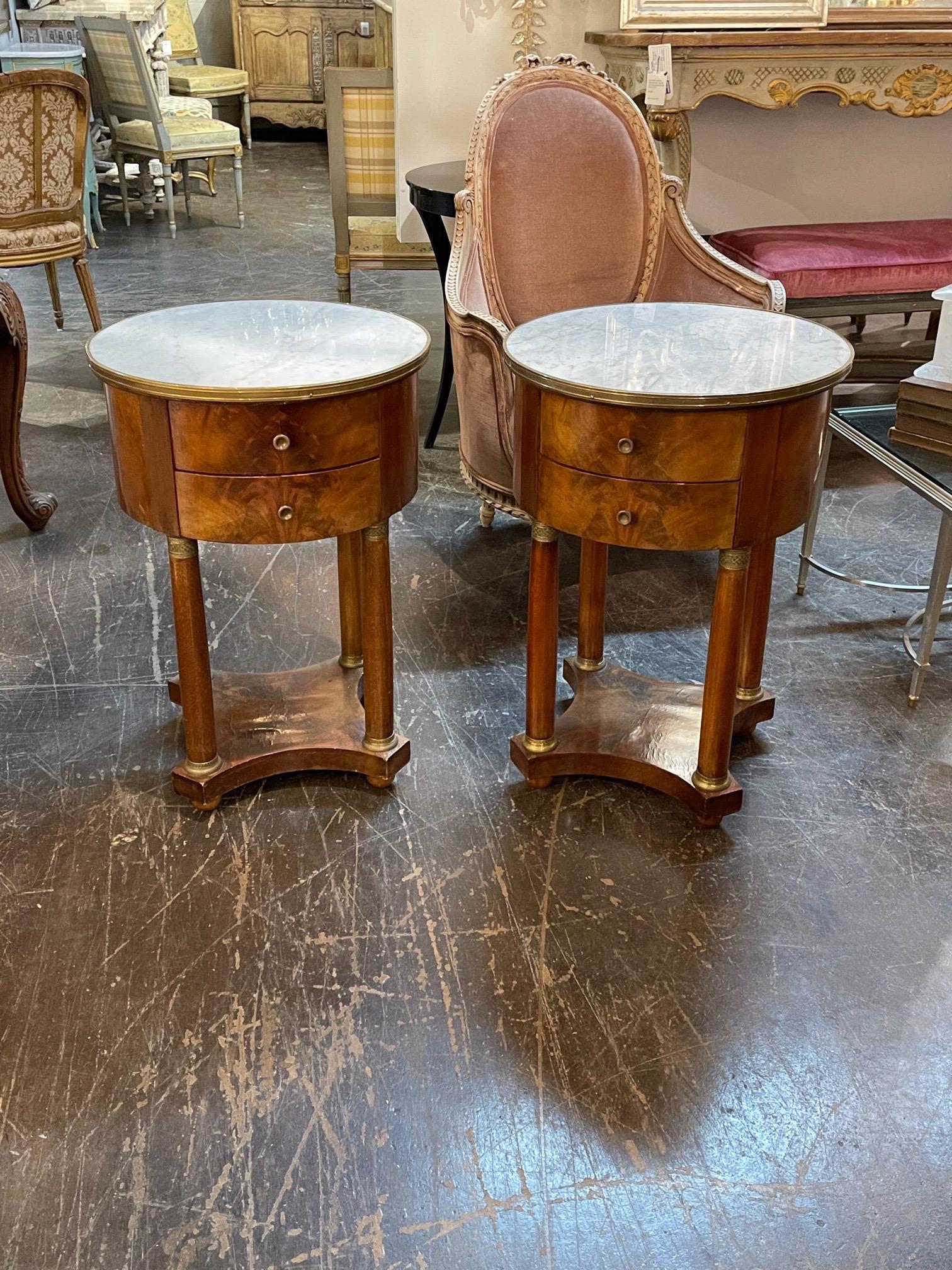 Handsome pair of 19th century French Empire mahogany side tables with marble tops. Very pretty finish and details on these. A Classic look! Note: Price listed is for 1.