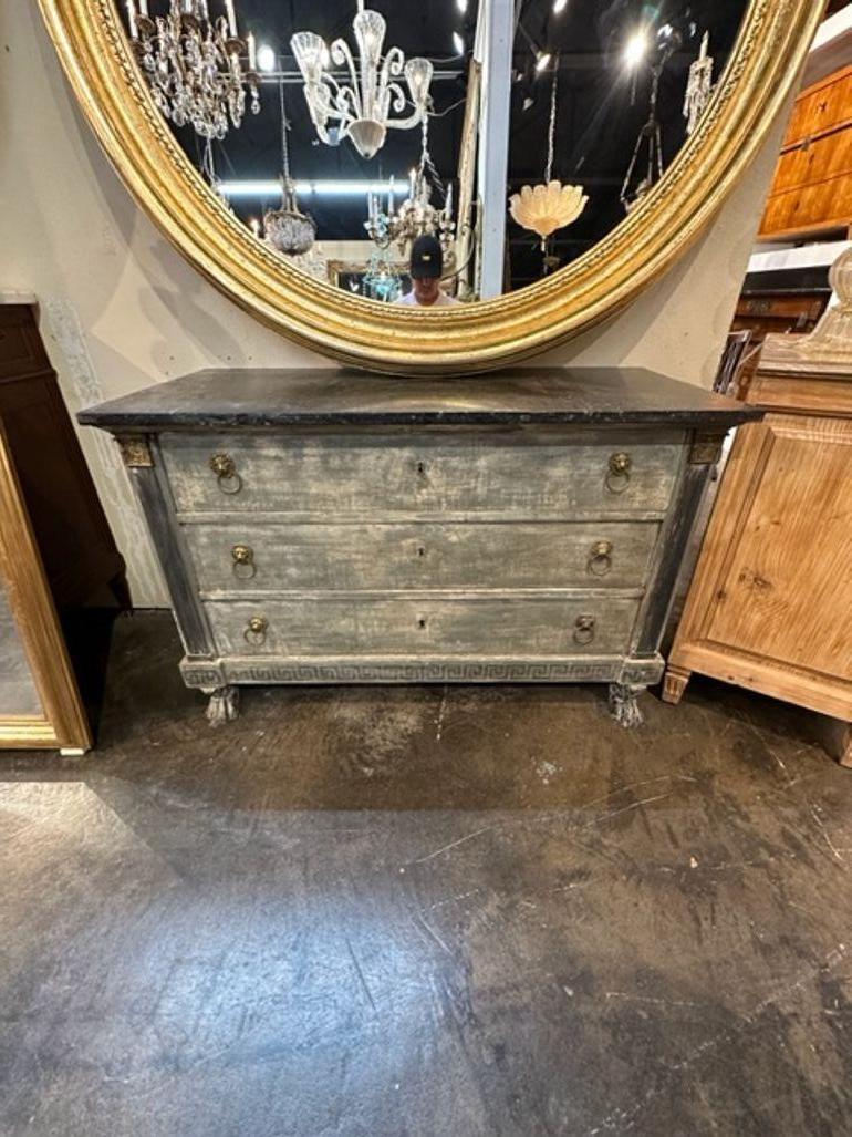 Elegant 19th century French Empire painted commode with black Belgian marble top. Nice patina and loads of storage. A great piece!