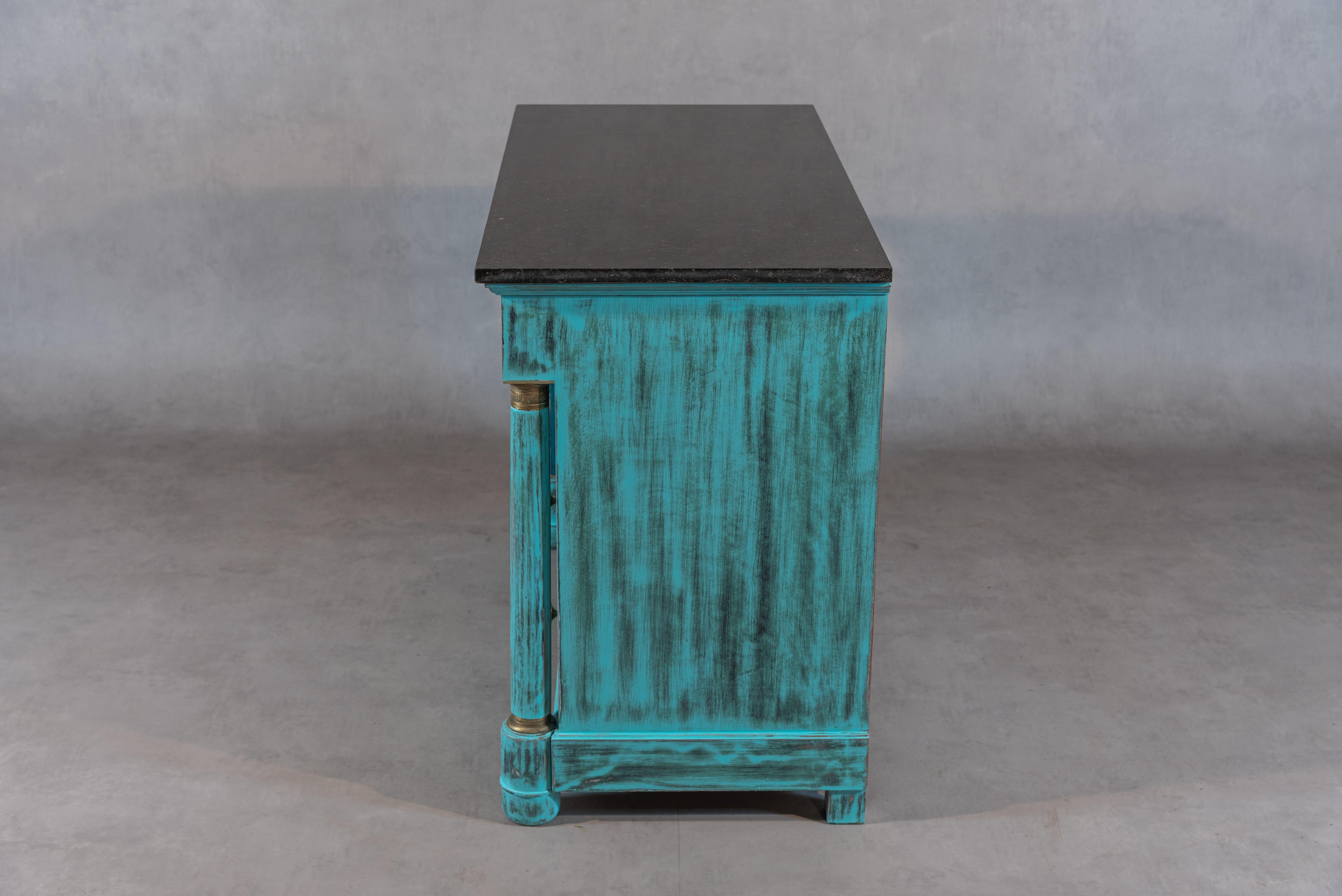 A beautiful French Empire Period Commode. This commode is made with mahogany wood and was professionally sanded, bleached, and painted in a unique turquoise patina. This commode has a marble top, exquisite brass features, and four ample drawers. It