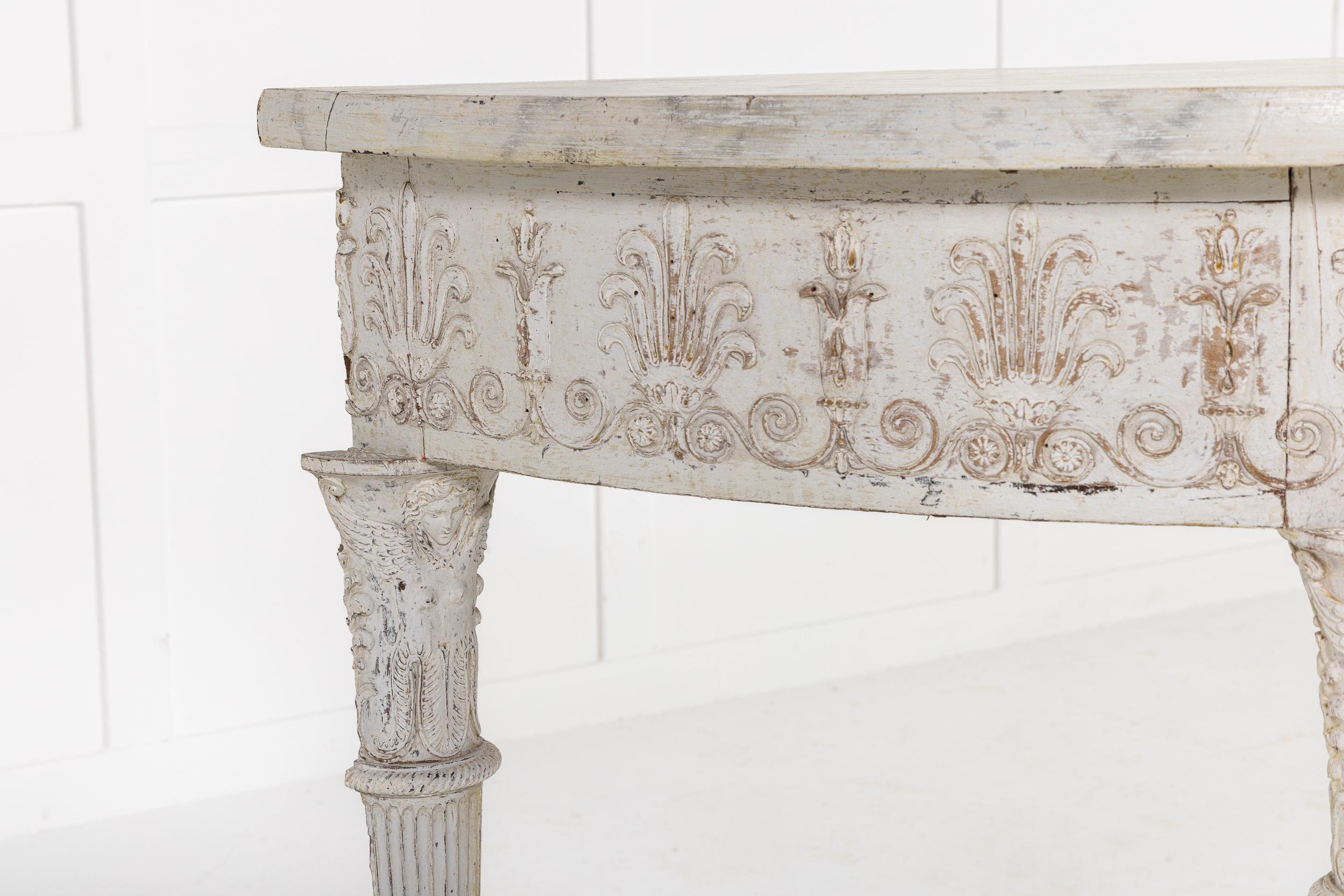 An Interesting and High Quality 19th Century French Empire Period Demi Lune Console or Side Table with Original Painted Surface and Faux Marble Top.

This lovely table is of demi lune form with its original paint has an undertier or stretcher of