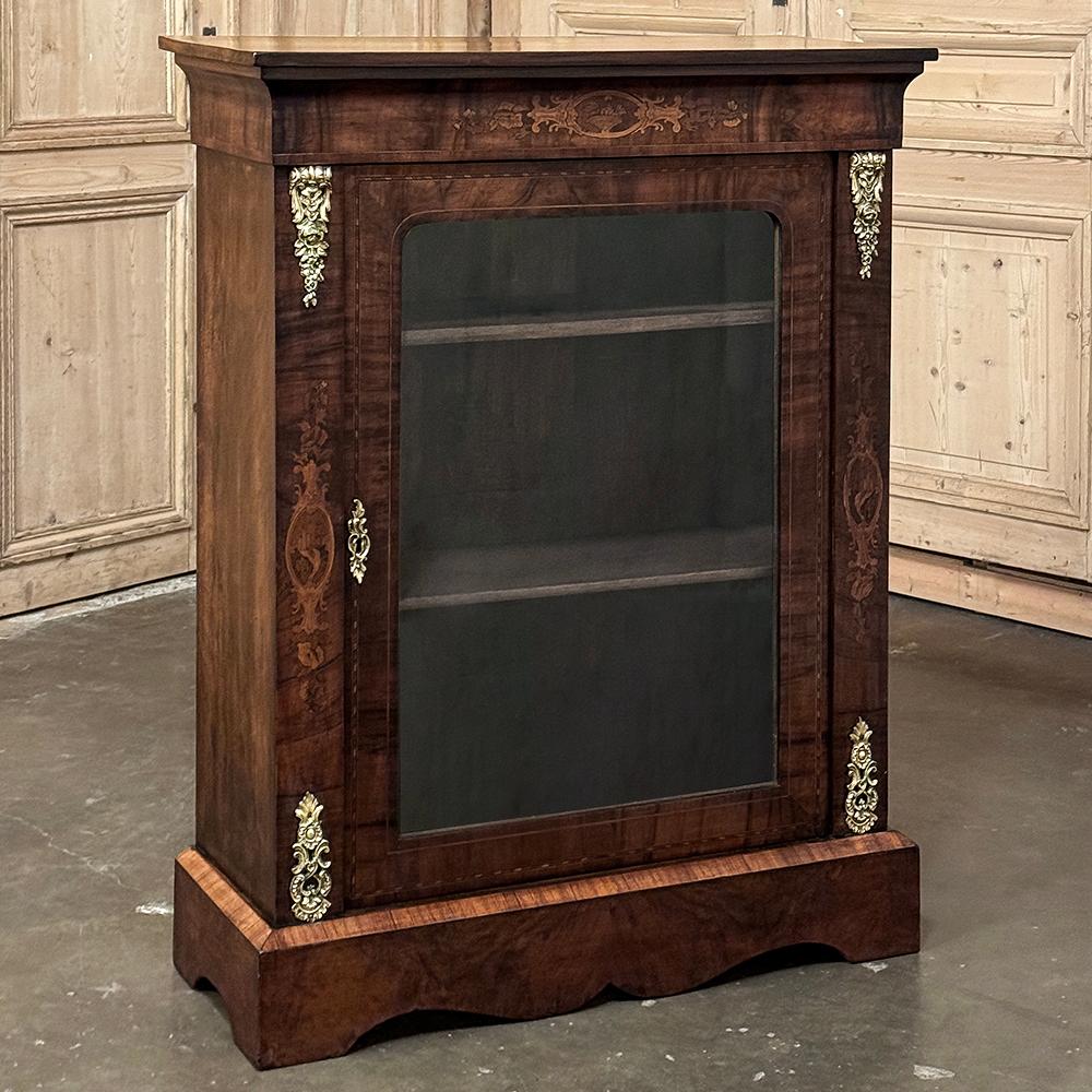 19th Century French Empire Revival Inlaid Walnut Vitrine is a splendid example of Old World craftsmanship in a style that was revived during the reign of Napoleon III.  Utilizing hand-picked, beautifully figured walnut, the artisans created a
