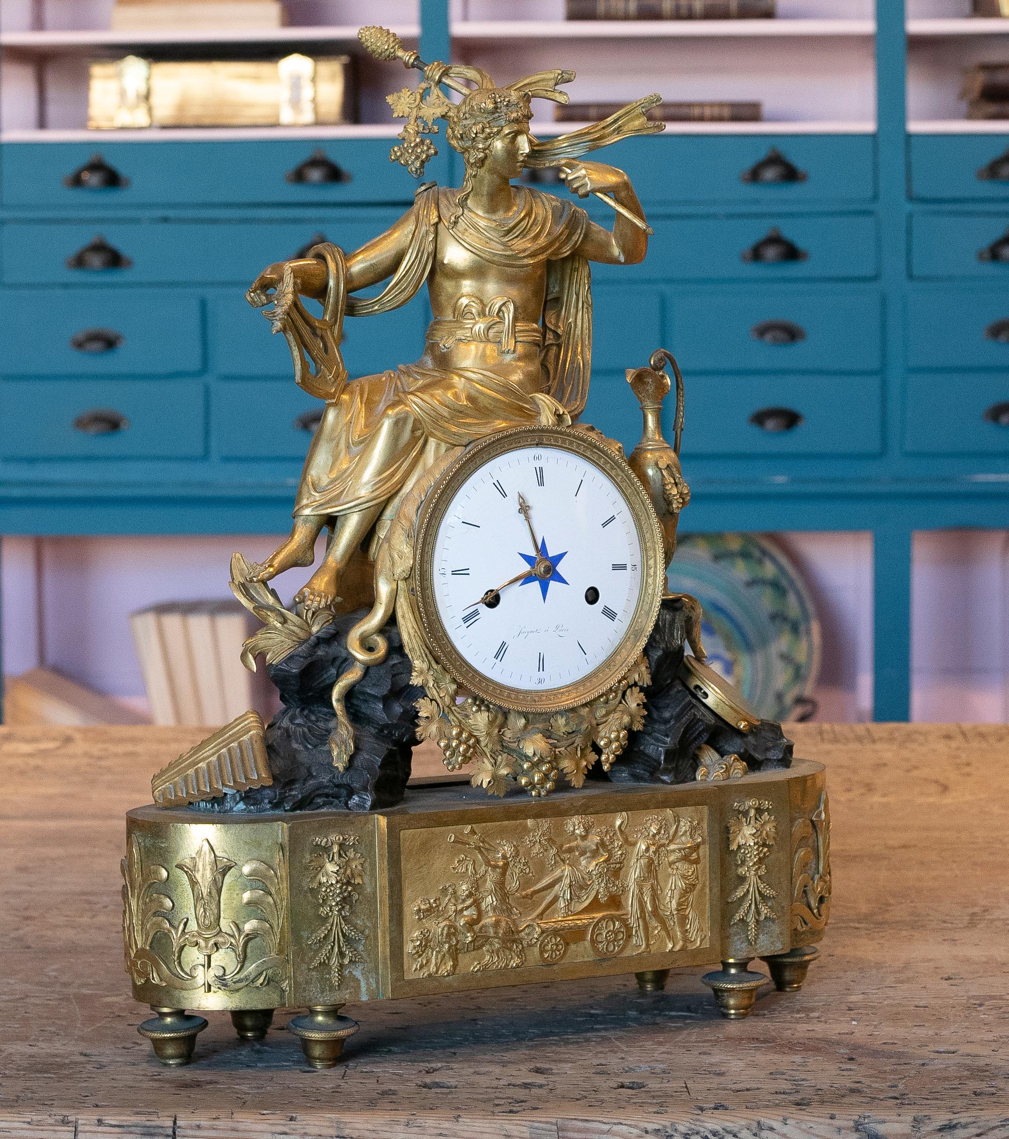 19th century French Empire style gilt bronze mantel (fireplace) clock with the dial inscribed JACQUOT A PARIS.
  