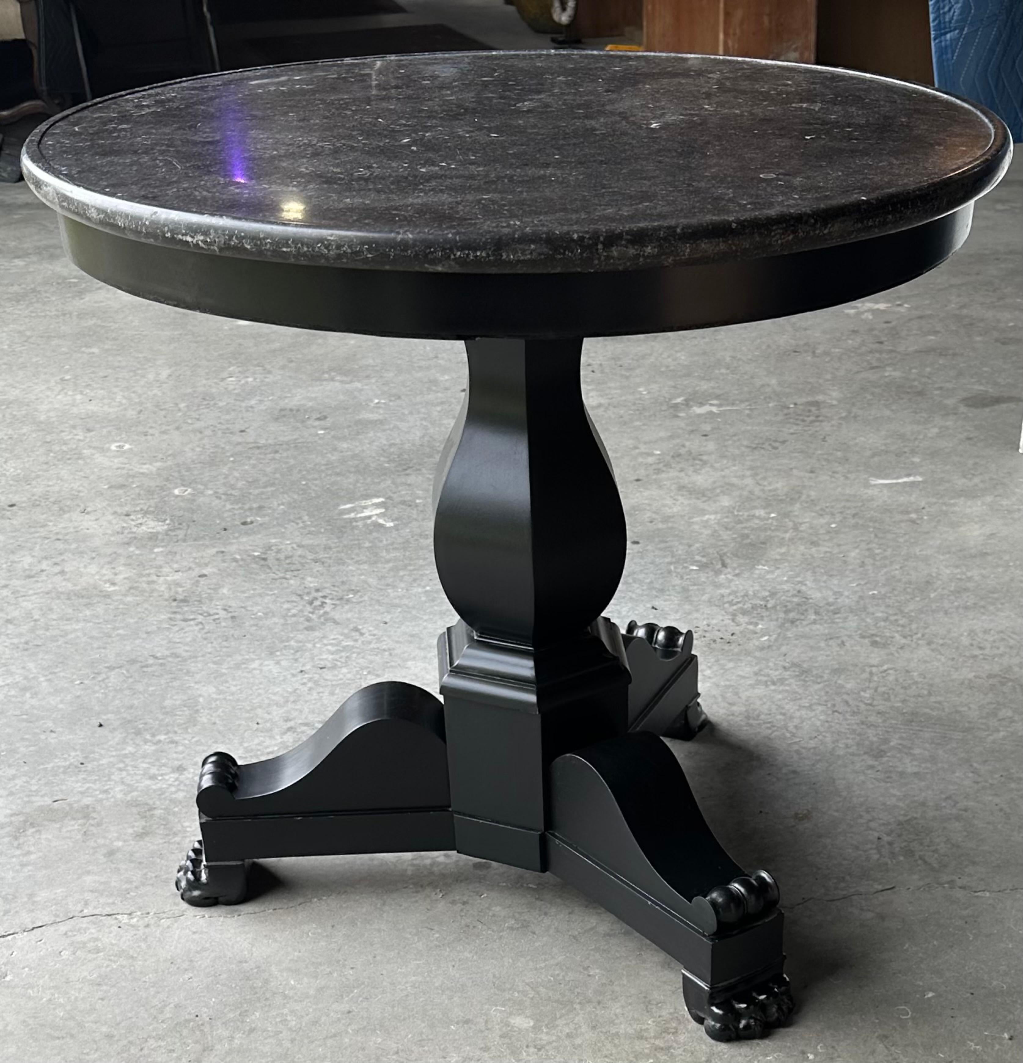A very handsome classical Empire-style round center table with a dark gray/black marble top, raised on a hand turned ebonized black center pedestal.  The table lends itself to be used for a breakfast table, side table, or an occasional table..
Base: