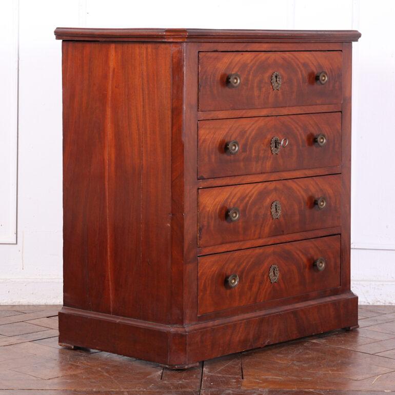 Smaller 19th century French Empire style four drawer chest, the drawers with book-matched flame mahogany veneering. 
Great piece for a generously-proportioned nightstand.