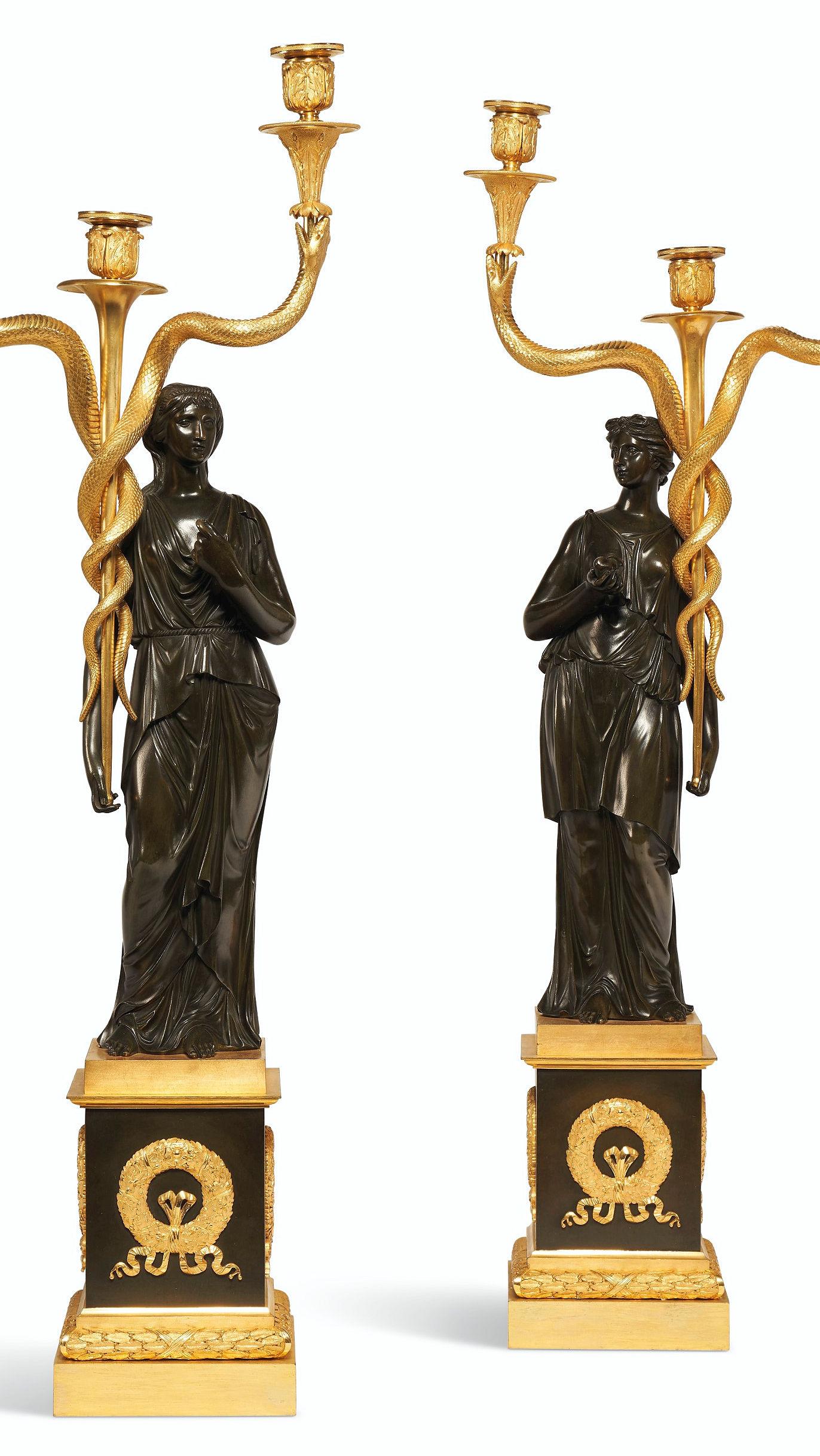 Our pair of antique (19th century) French ormolu and patinated bronze three-light candelabra are of the highest quality, 
 with neoclassical female figures holding candle arms in the form of a entwined snakes on square pedestals decorated with