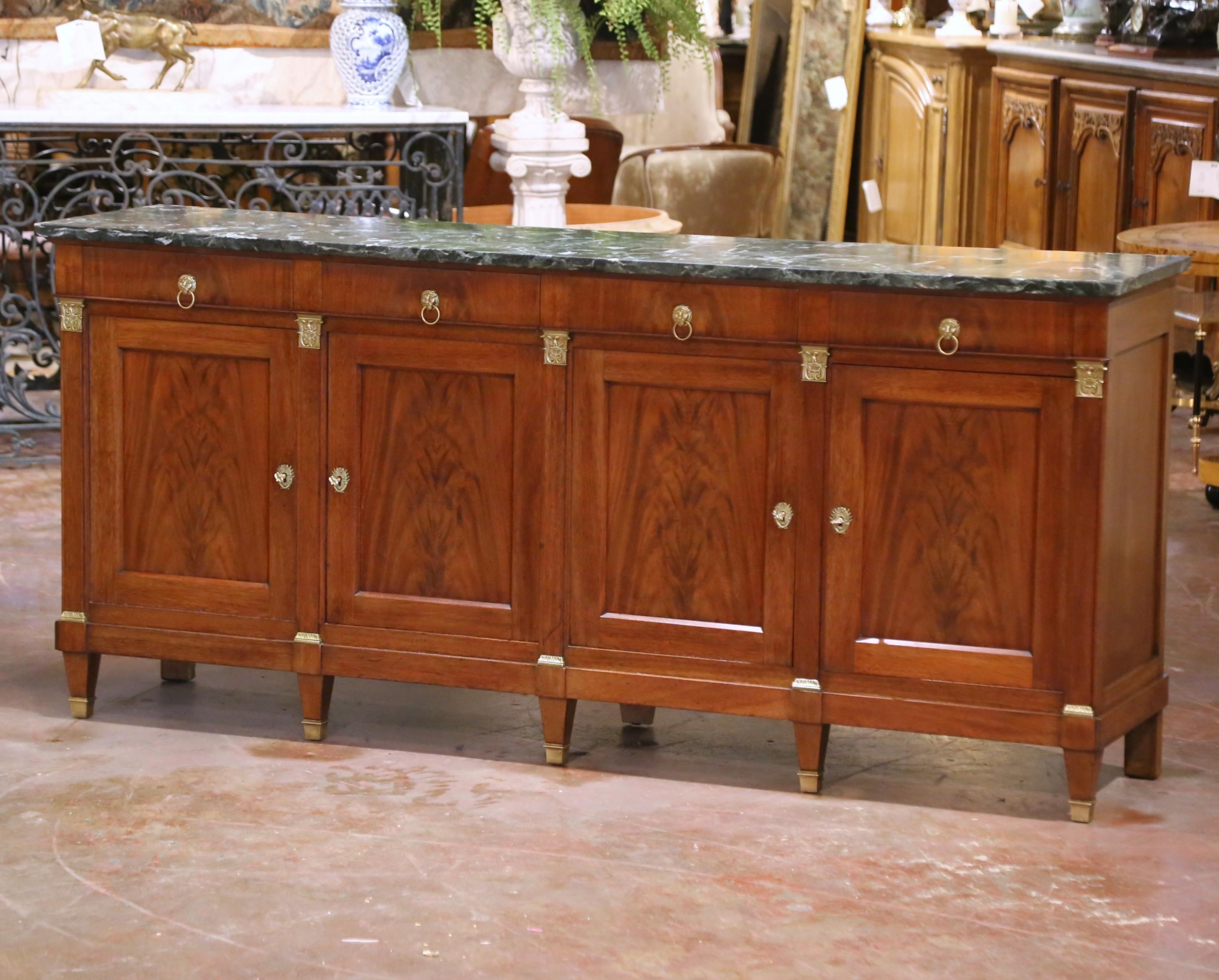Crafted in France circa 1880, this stately 19th-century Empire style sideboard is constructed from richly figured walnut and dressed with its original 