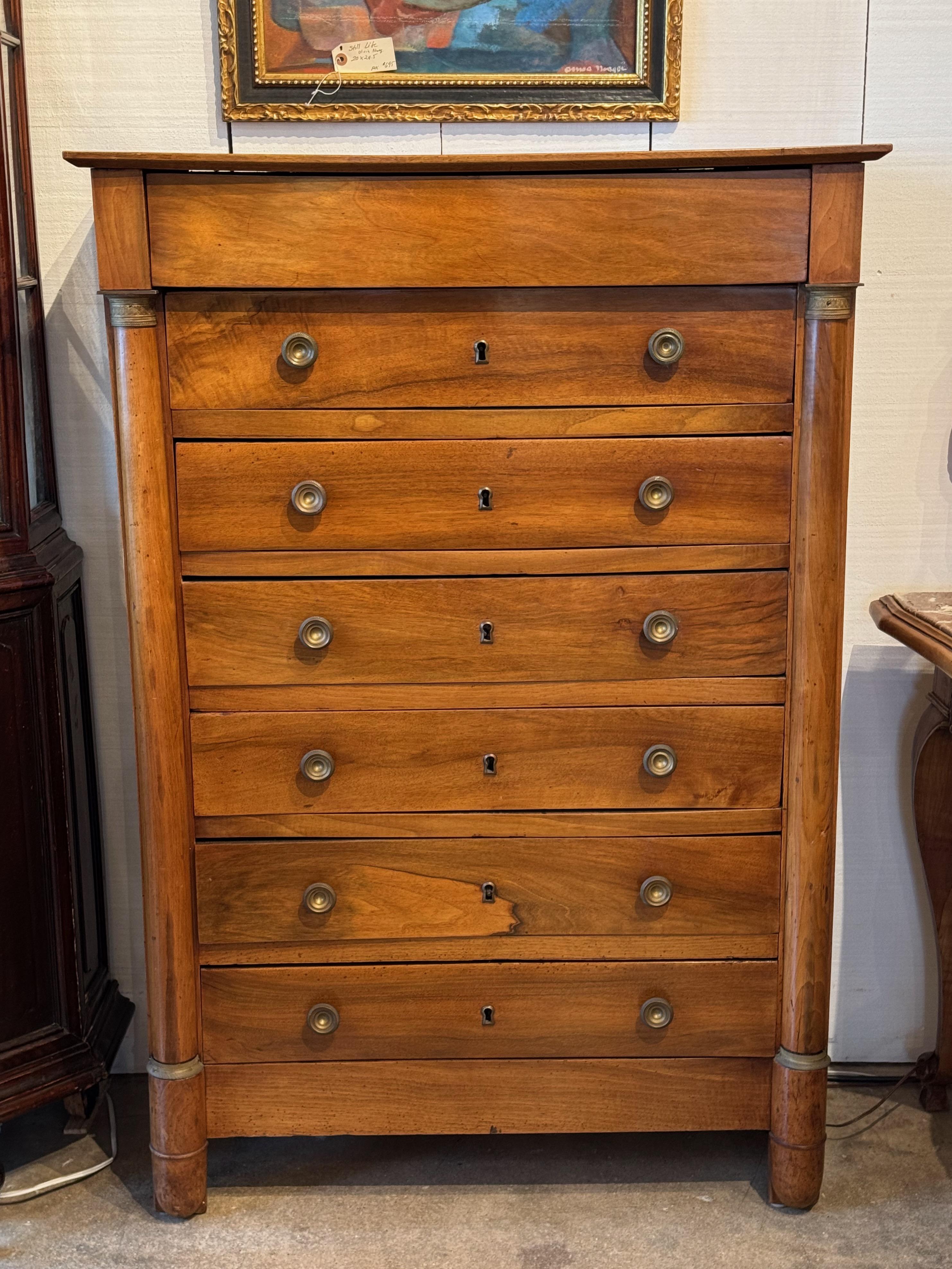 Cassettone in stile Impero francese del XIX secolo con sei cassetti e supporti a colonna arrotondati con capitelli e basi in ottone. Realizzato in noce pregiato, con originali tiretti in ottone e incastri a coda di rondine tagliati a mano. Una