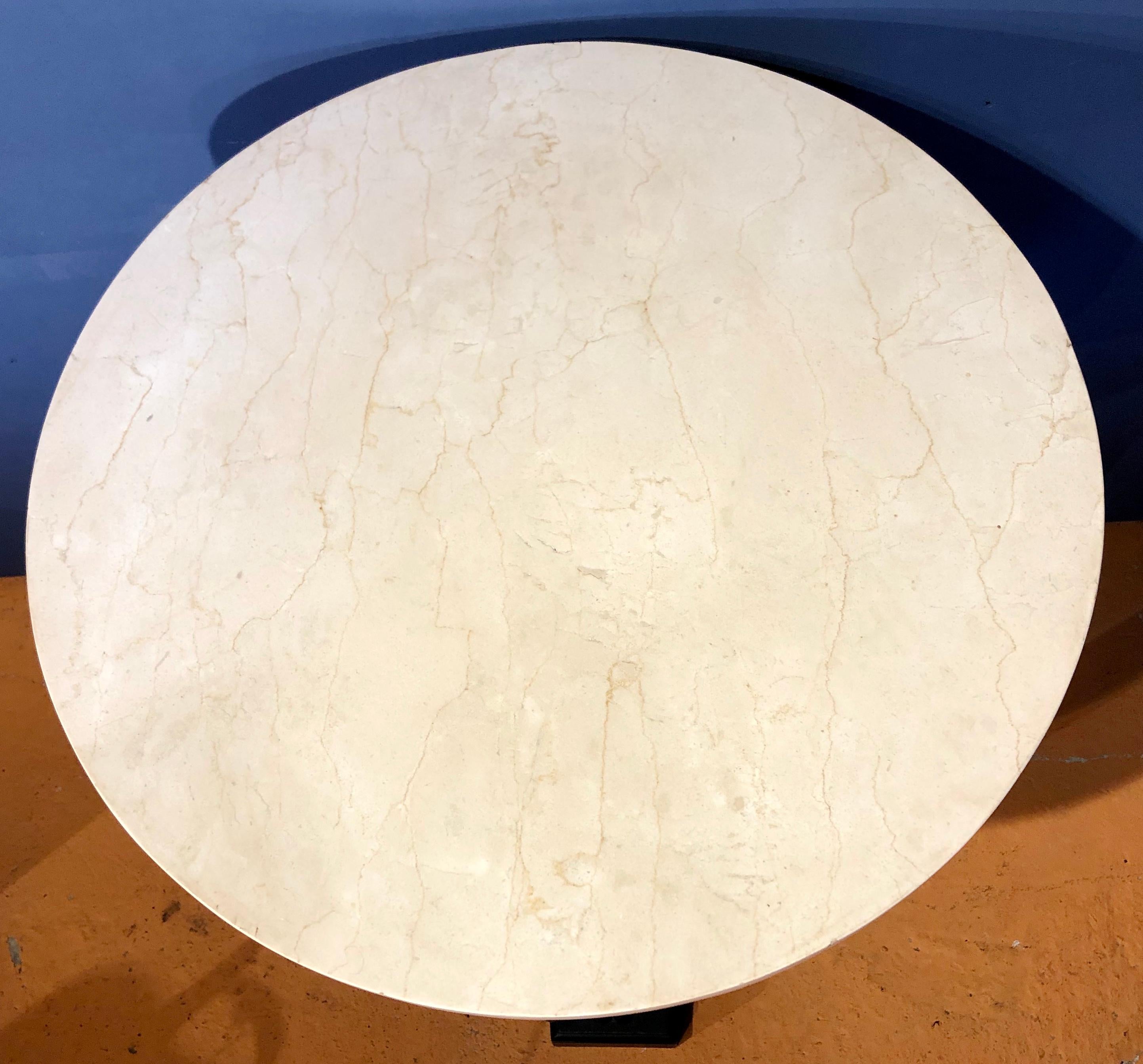 A very attractive tall painted French guéridon or center table of good proportions in the Empire taste. The thick white marble top supported by a frieze with a repeat foliate pattern broken only by the three lion mask paterae at the top of each