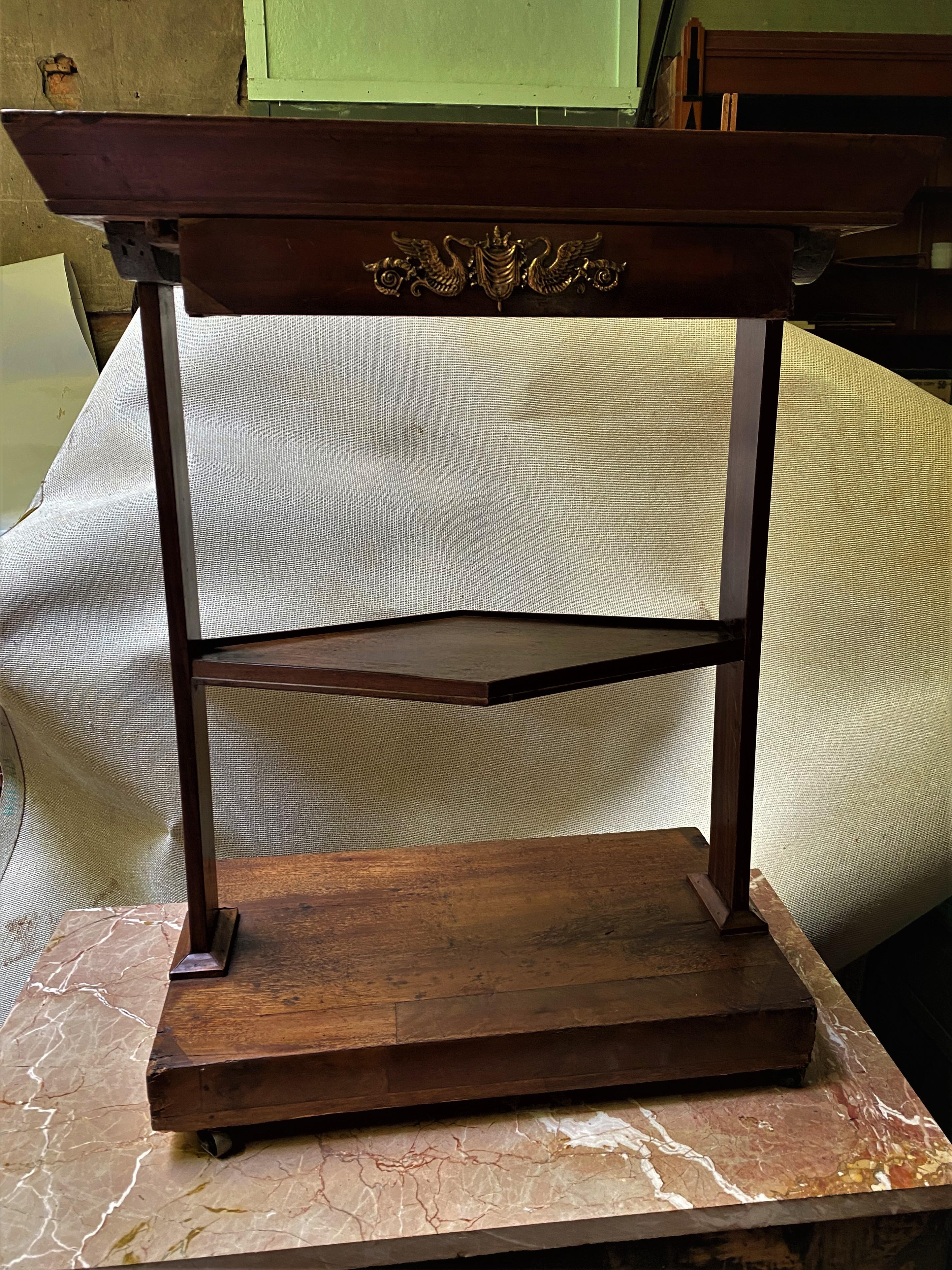 This is the sweetest small table with great mahogany grained veneer and a nice 1 1/2 inch deep tray top. It rolls easily on brass castors and the diamond shaped shelf with a fine edge is classy, but the table has many repairs and signs of age and